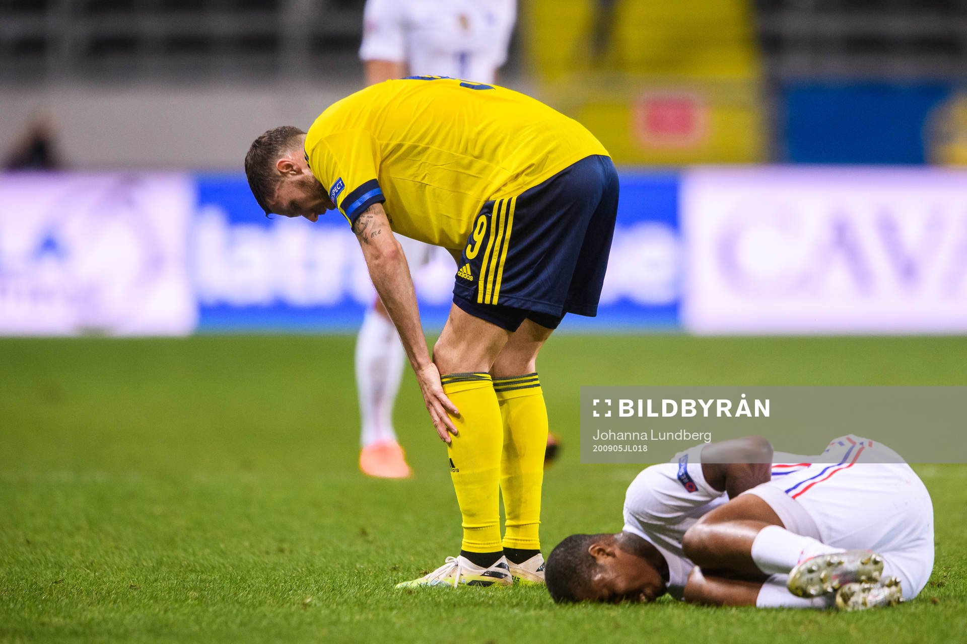 Marcus Berg of Sweden and Presnel Kimpembe of France in pain