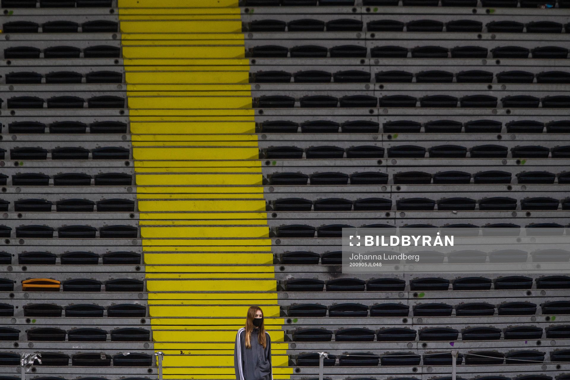A volunteer in front of empty stands