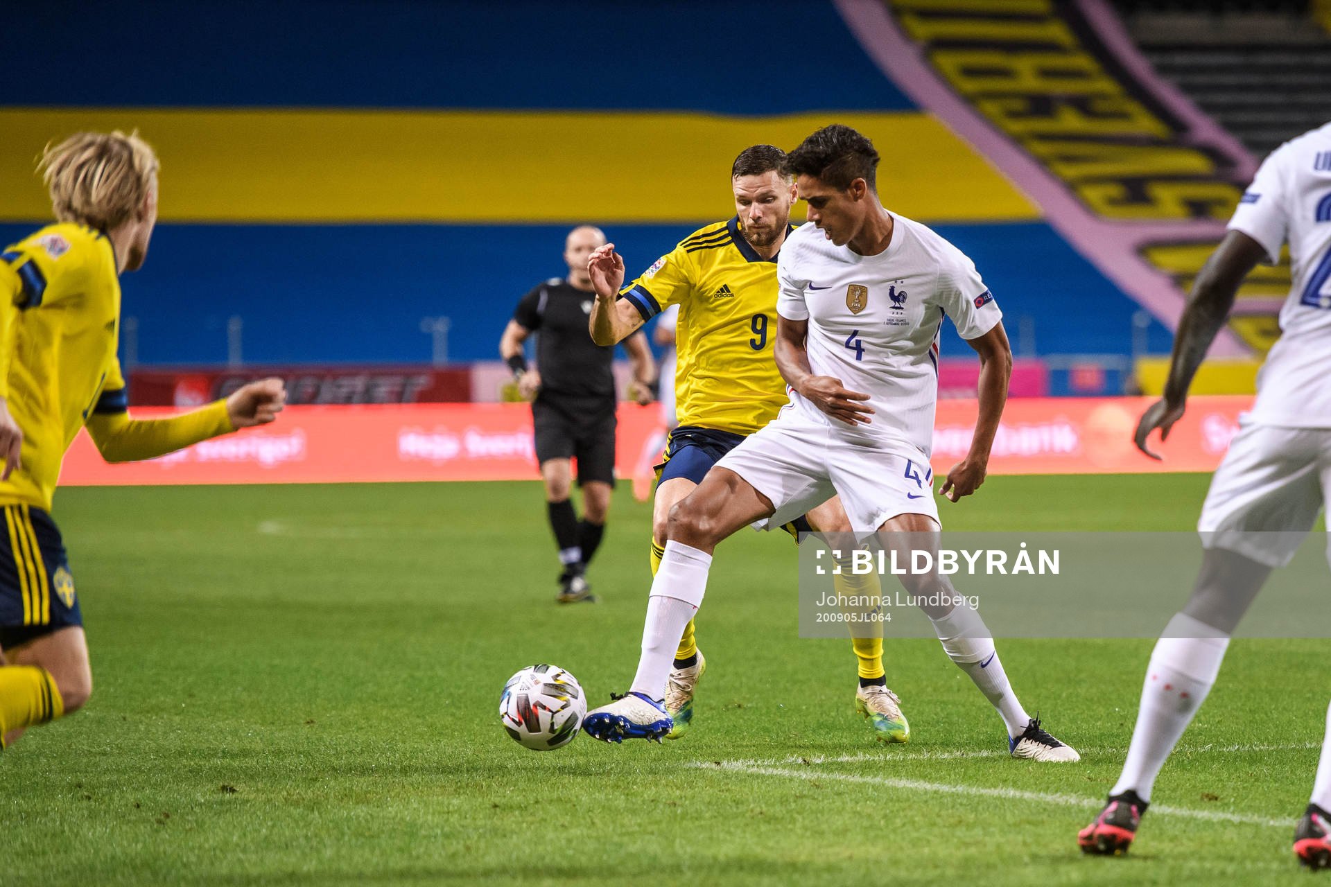 Marcus Berg of Sweden and Raphaël Varane of France