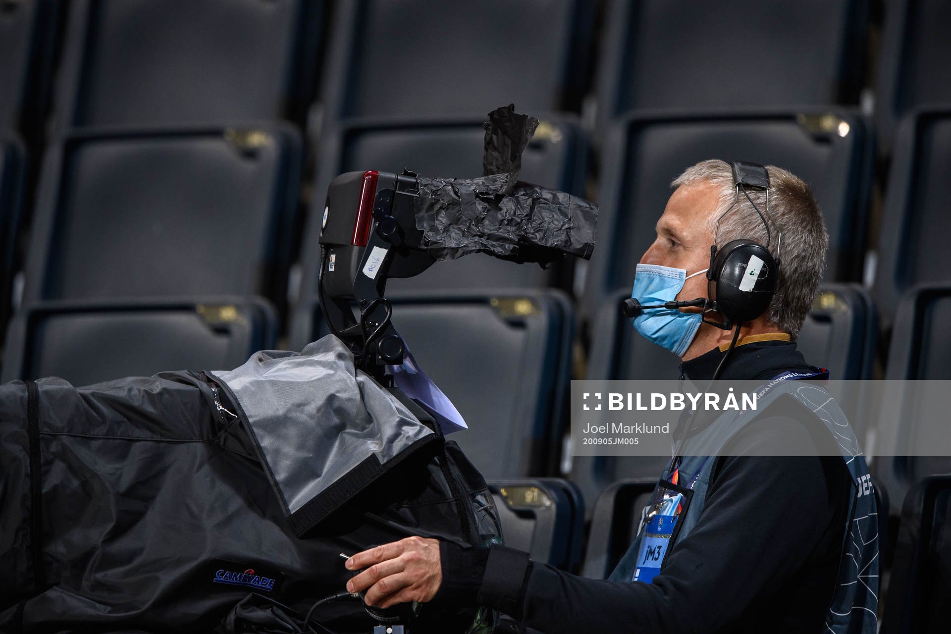 A camera man with respiratory protection due to the corona