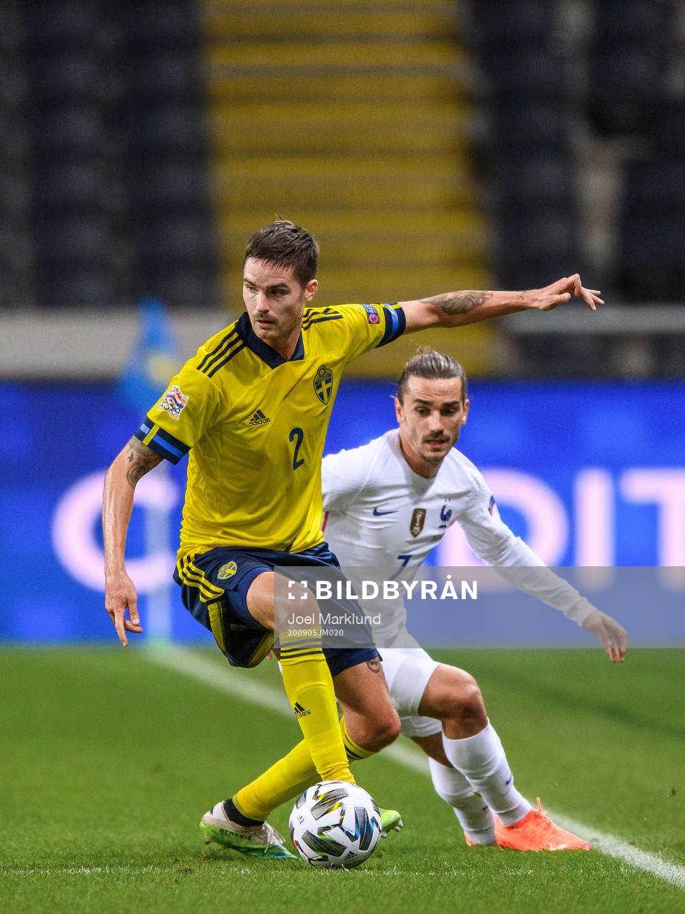 Mikael Lustig of Sweden and Antoine Griezmann of France