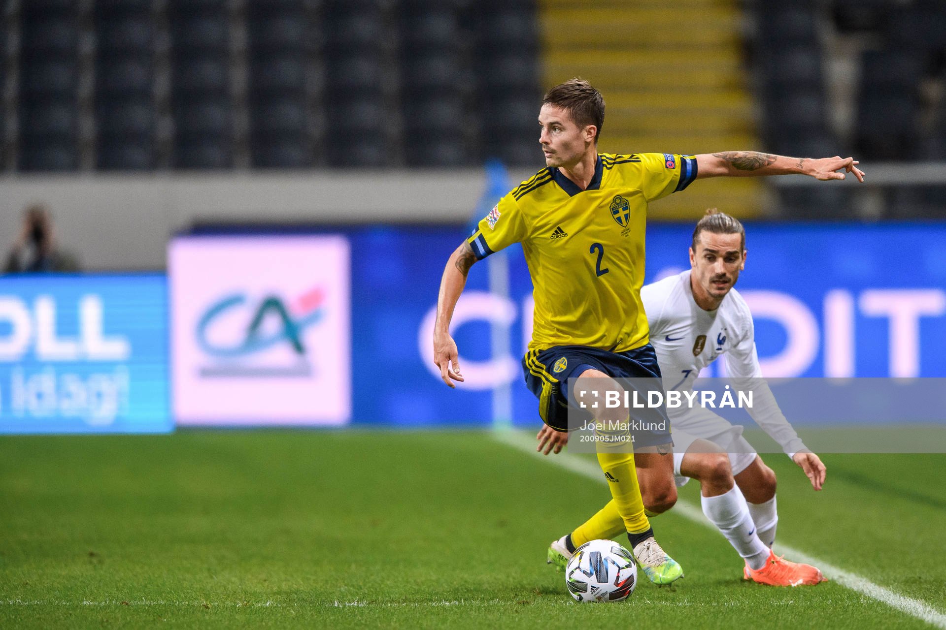 Mikael Lustig of Sweden and Antoine Griezmann of France