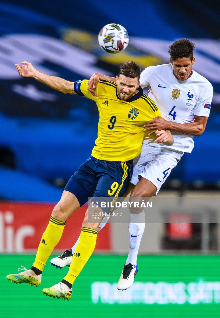 Marcus Berg of Sweden and Raphaël Varane of France