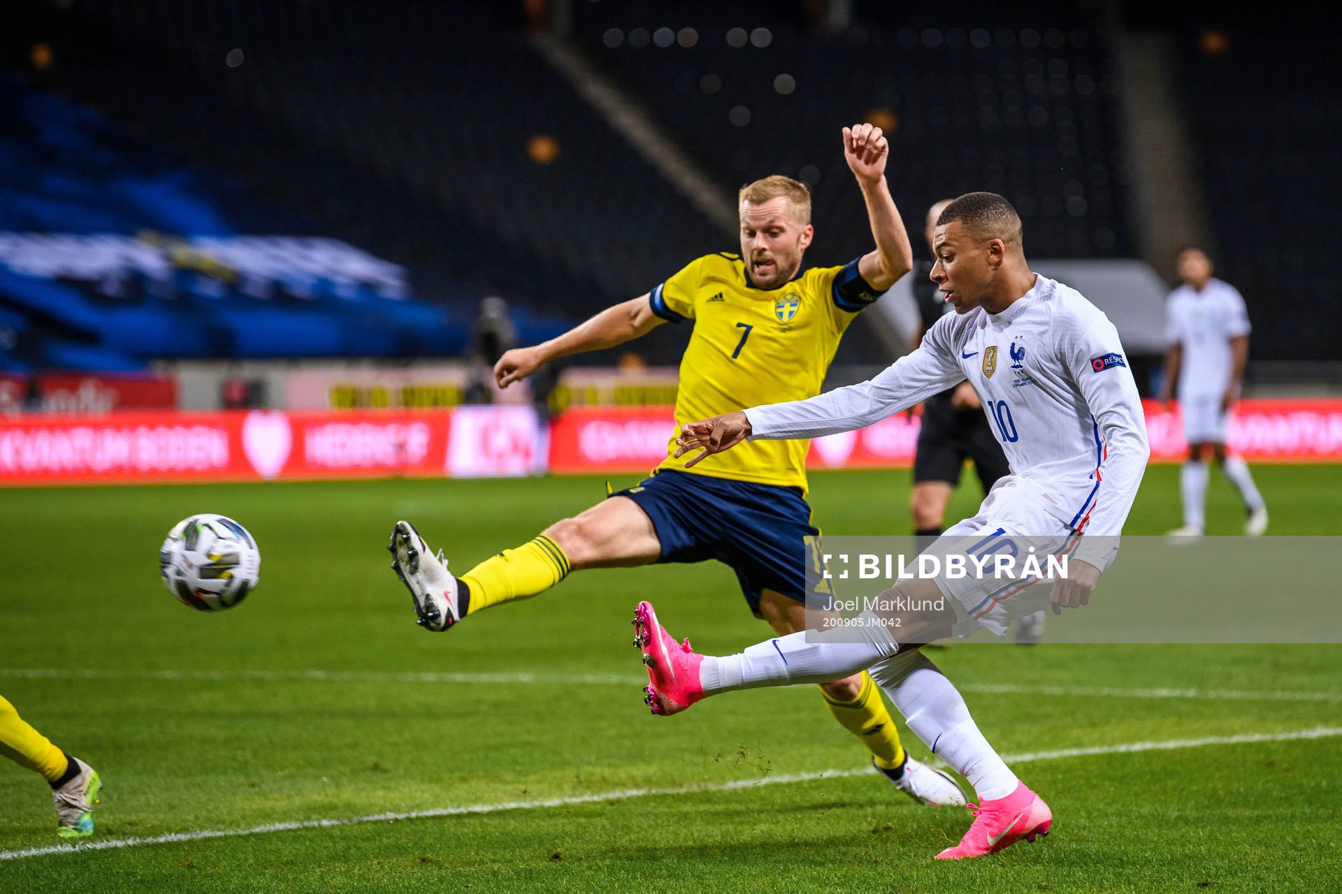 Sebastian Larsson of Sweden and Kylian Mbappé of France
