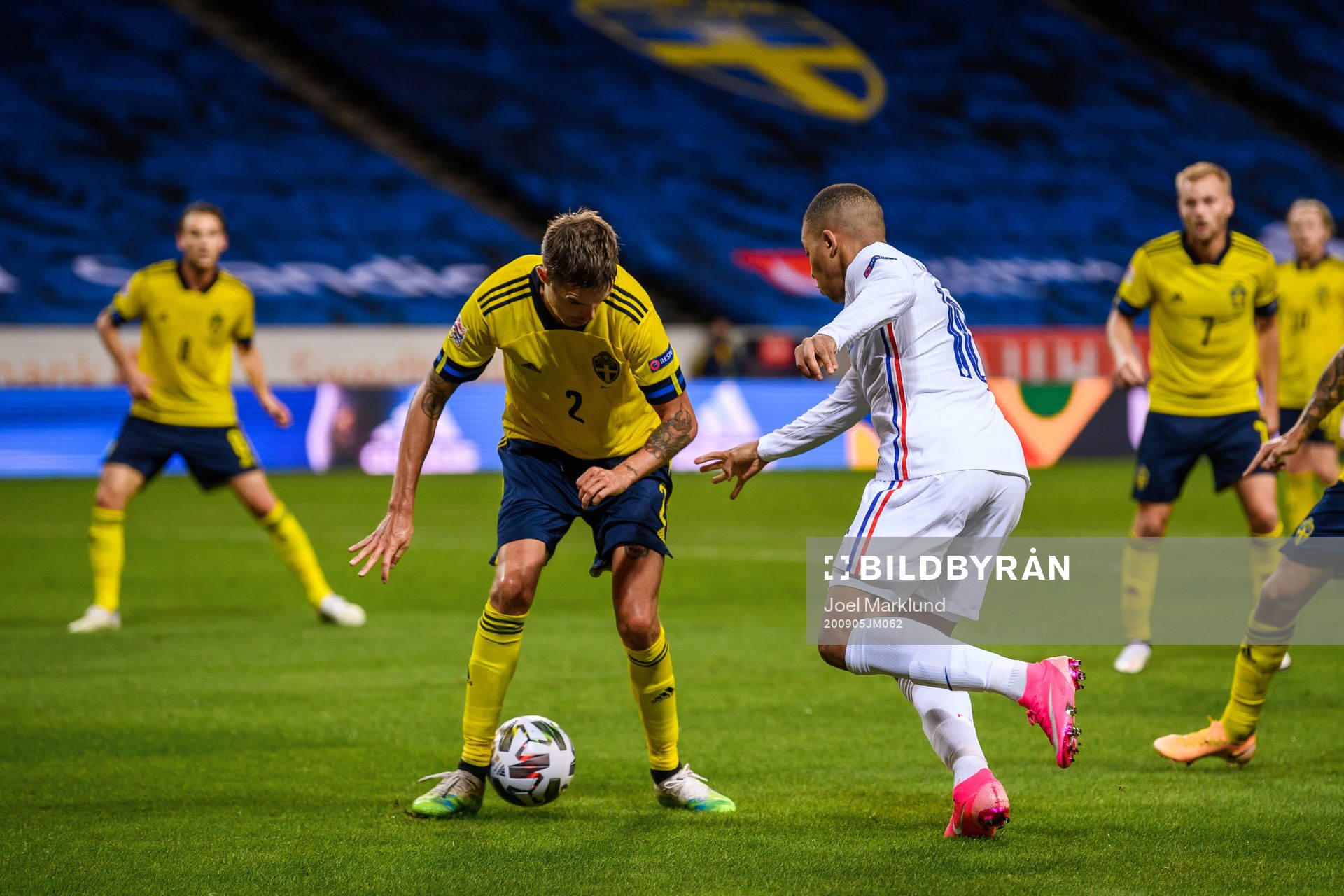 Mikael Lustig of Sweden and Kylian Mbappé of France