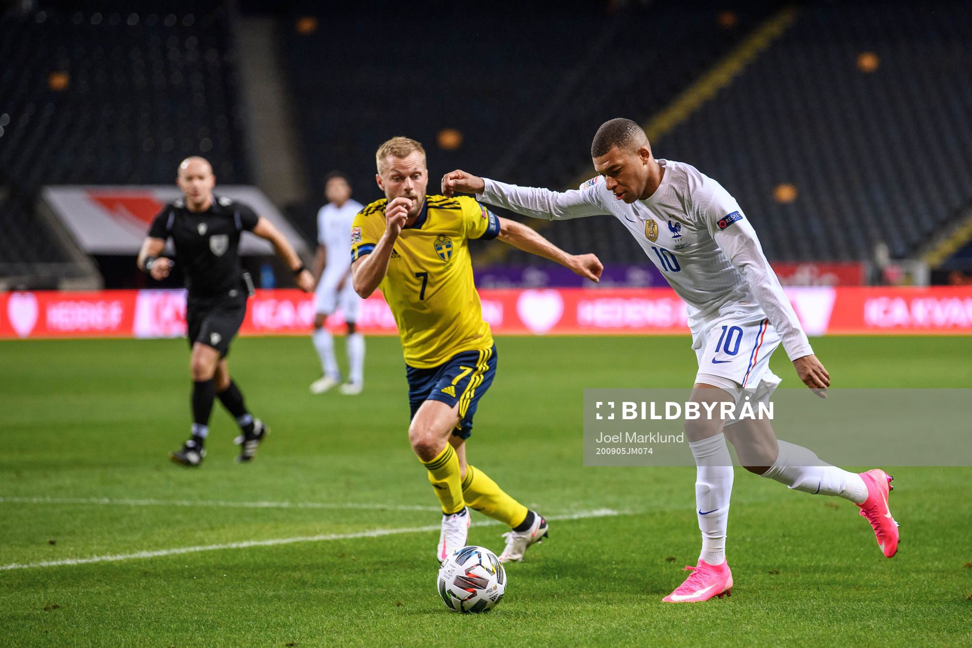 Sebastian Larsson of Sweden and Kylian Mbappé of France
