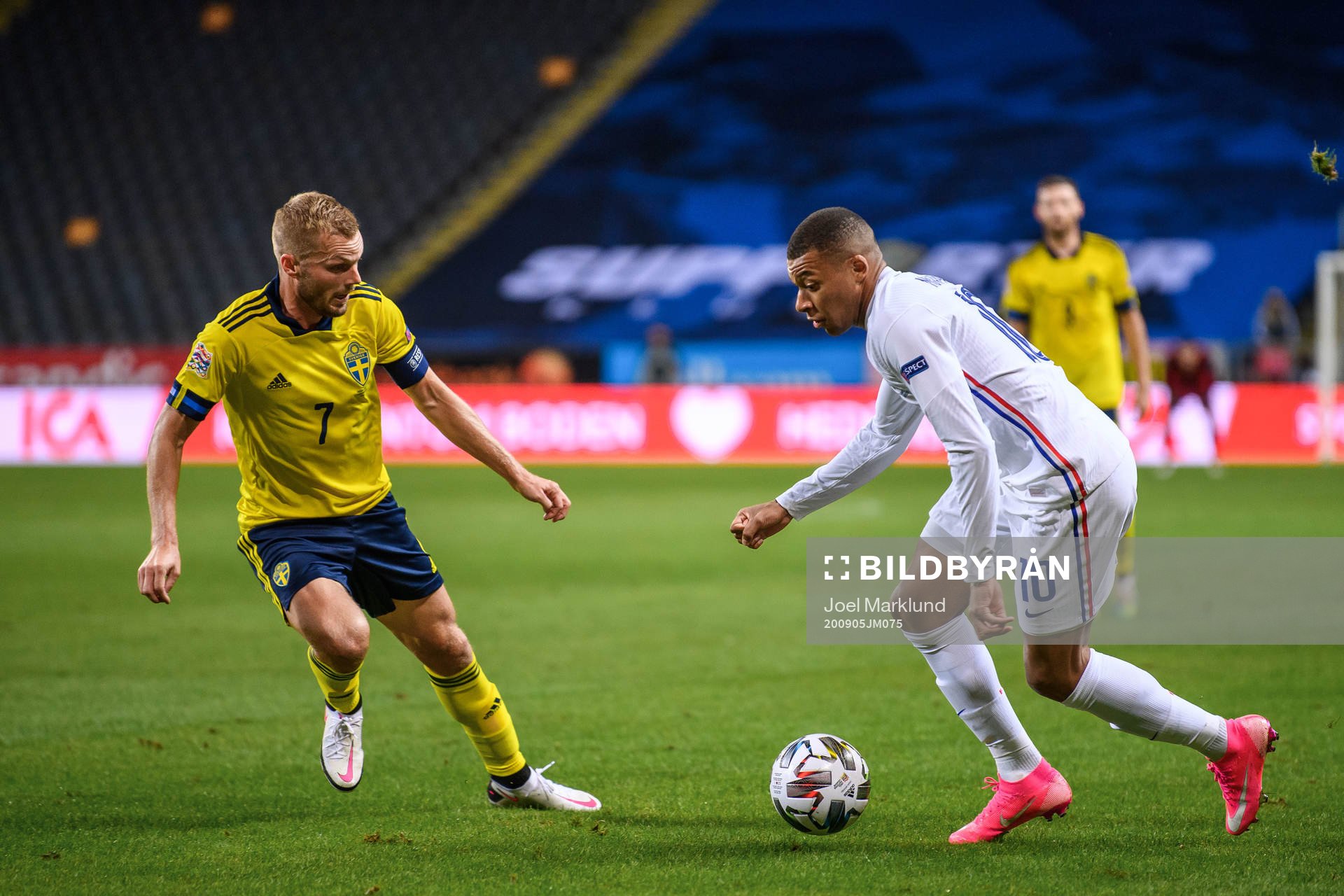 Sebastian Larsson of Sweden and Kylian Mbappé of France