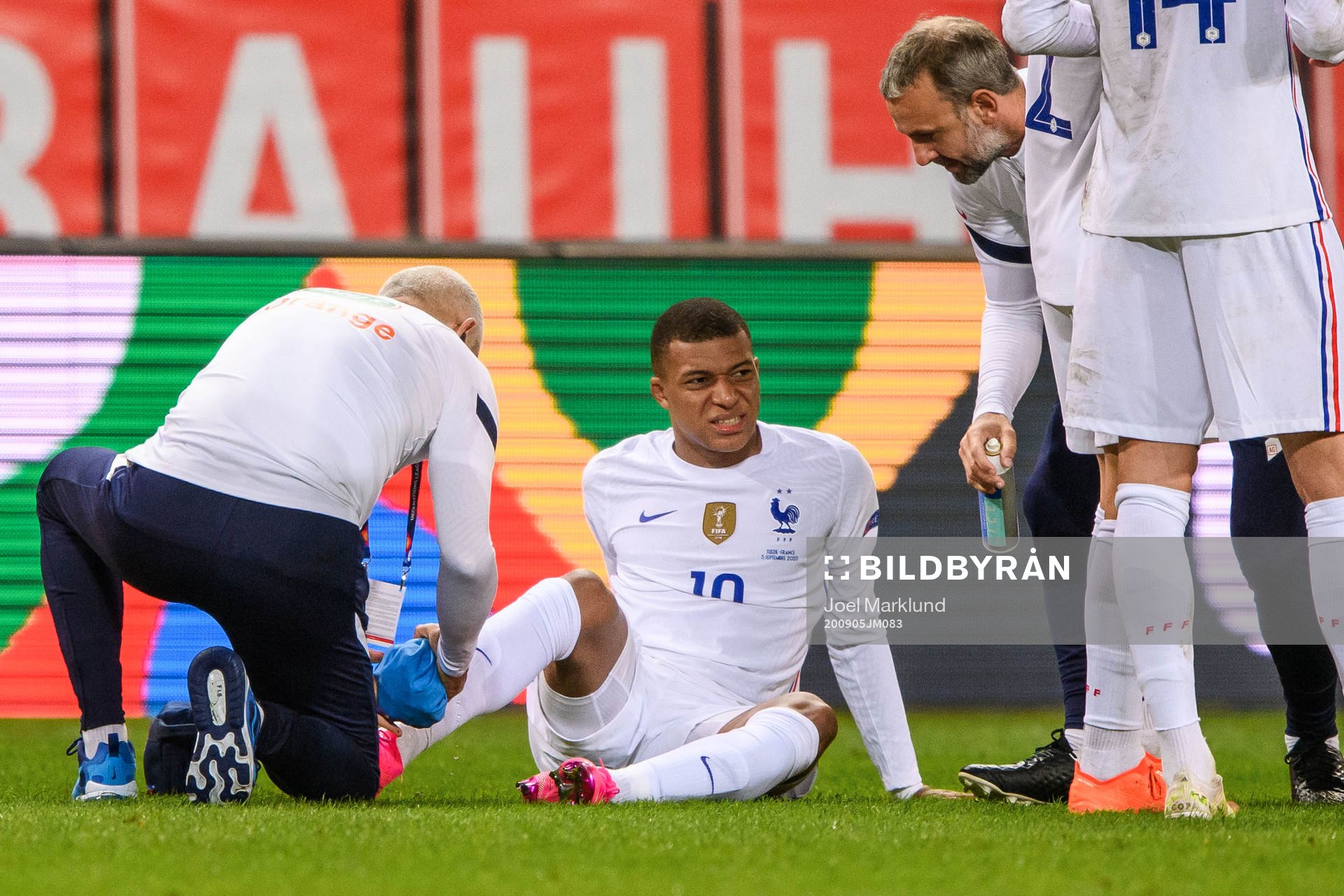 Kylian Mbappé of France receives medical attention