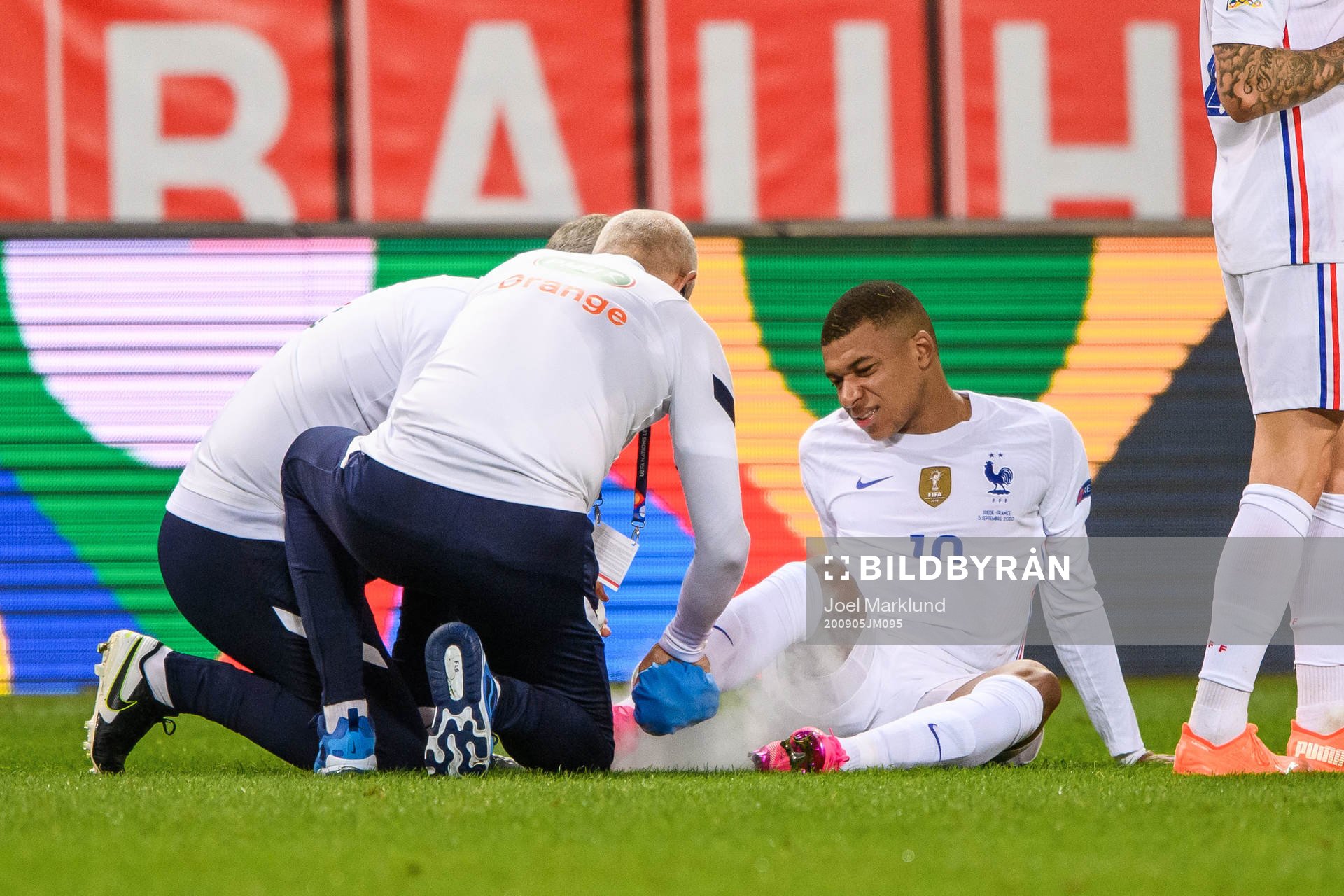 Kylian Mbappé of France receives medical attention