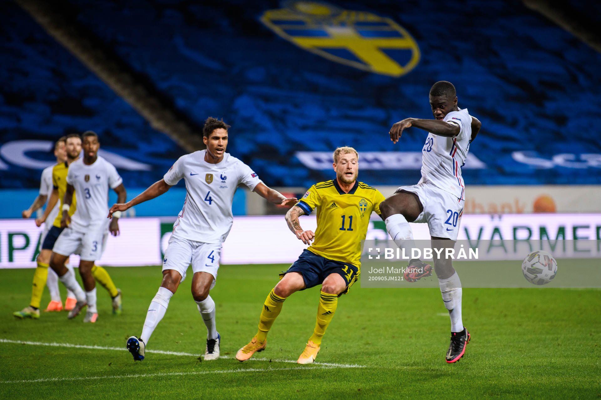 Dayot Upamecano and Raphaël Varane of France against John