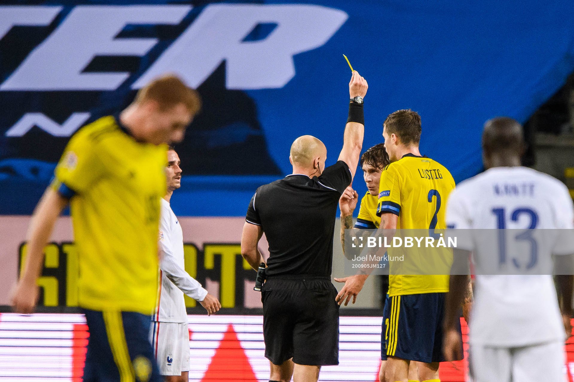 Victor Nilsson Lindelöf of Sweden receives a yellow card