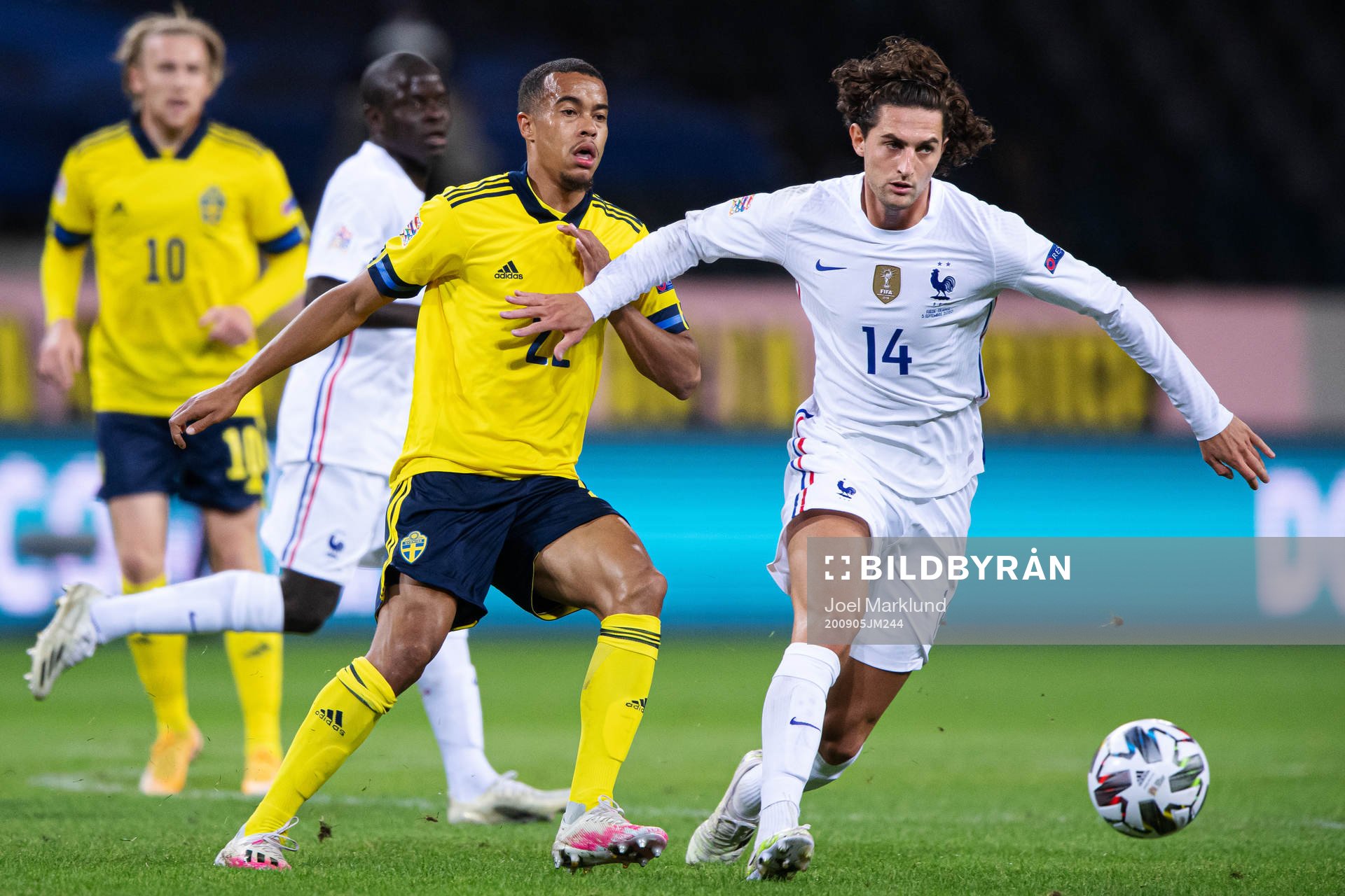 Robin Quaison of Sweden and Adrien Rabiot of France