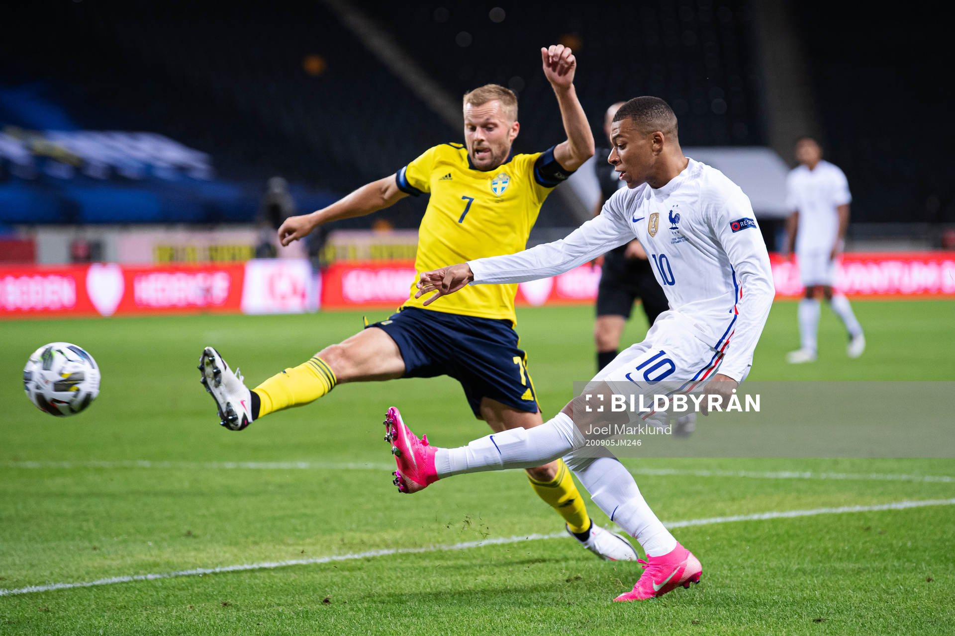 Sebastian Larsson of Sweden and Kylian Mbappé of France