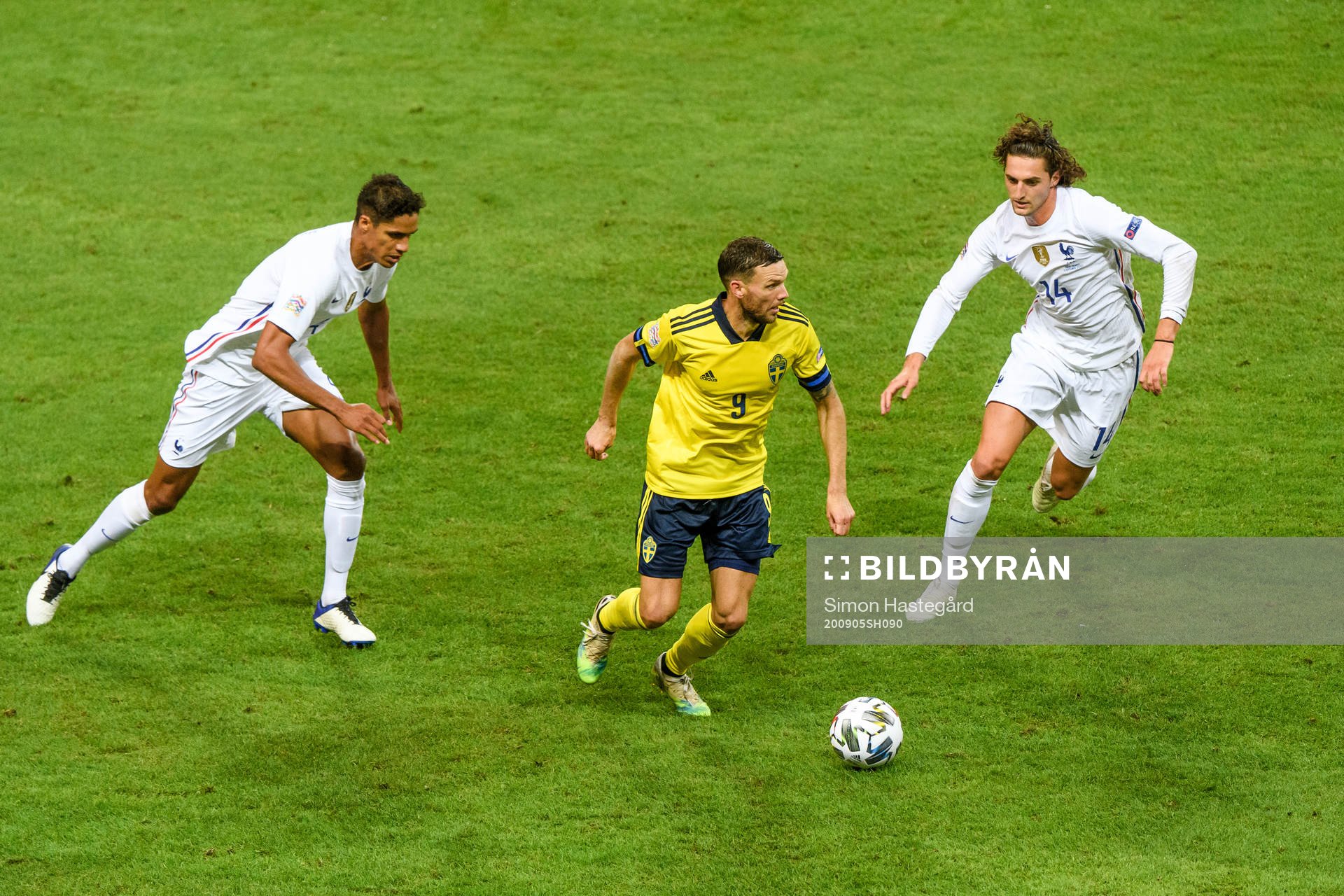 Marcus Berg of Sweden against Raphaël Varane and Adrien