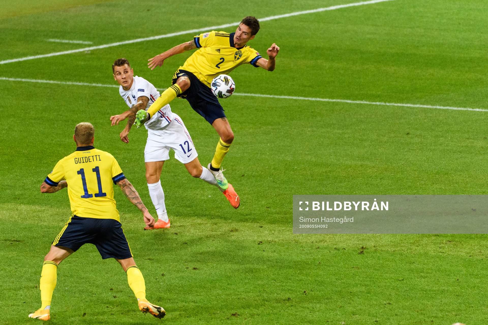 Mikael Lustig and John Guidetti of Sweden against Lucas