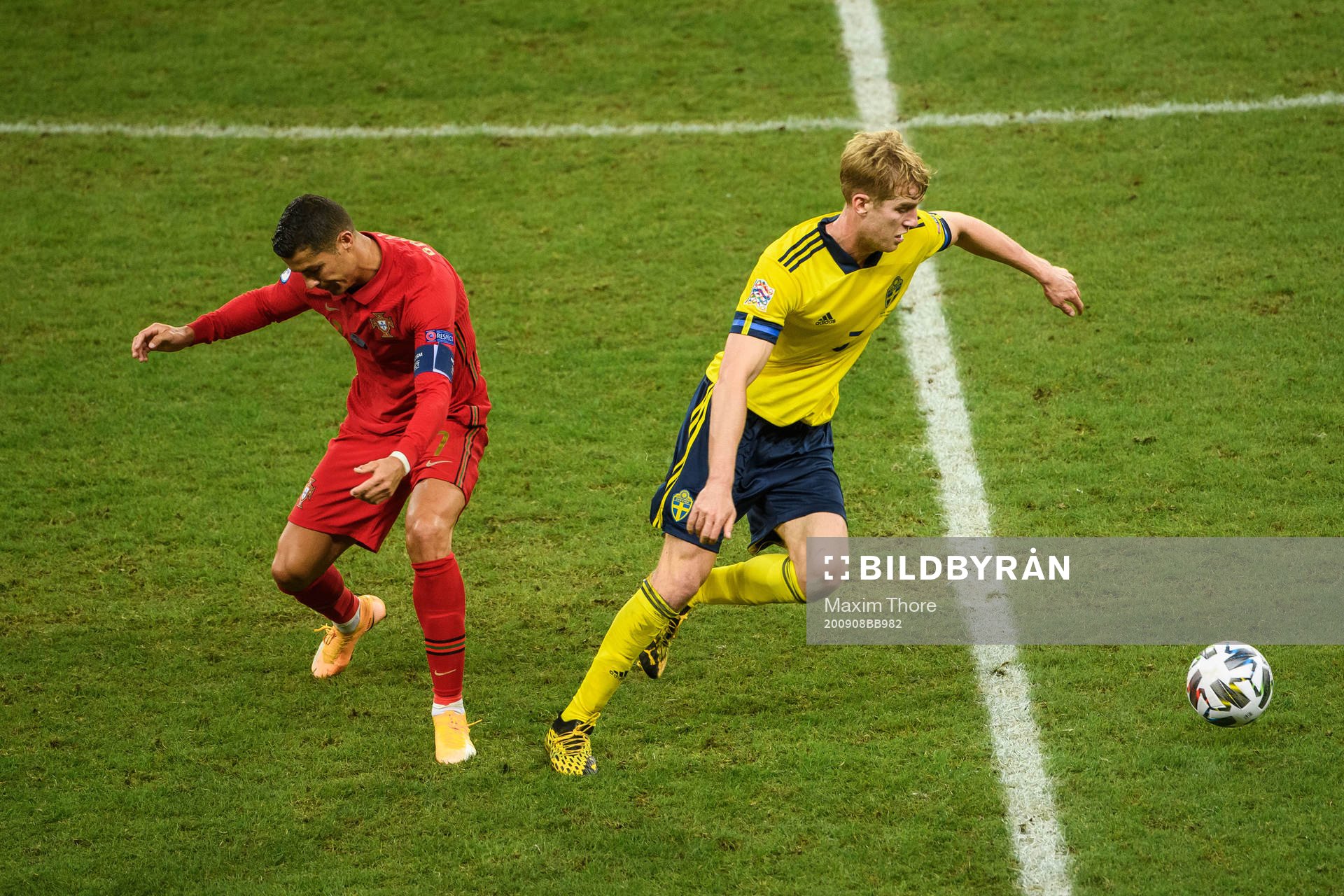 Cristiano Ronaldo of Portugal and Filip Helander of Sweden