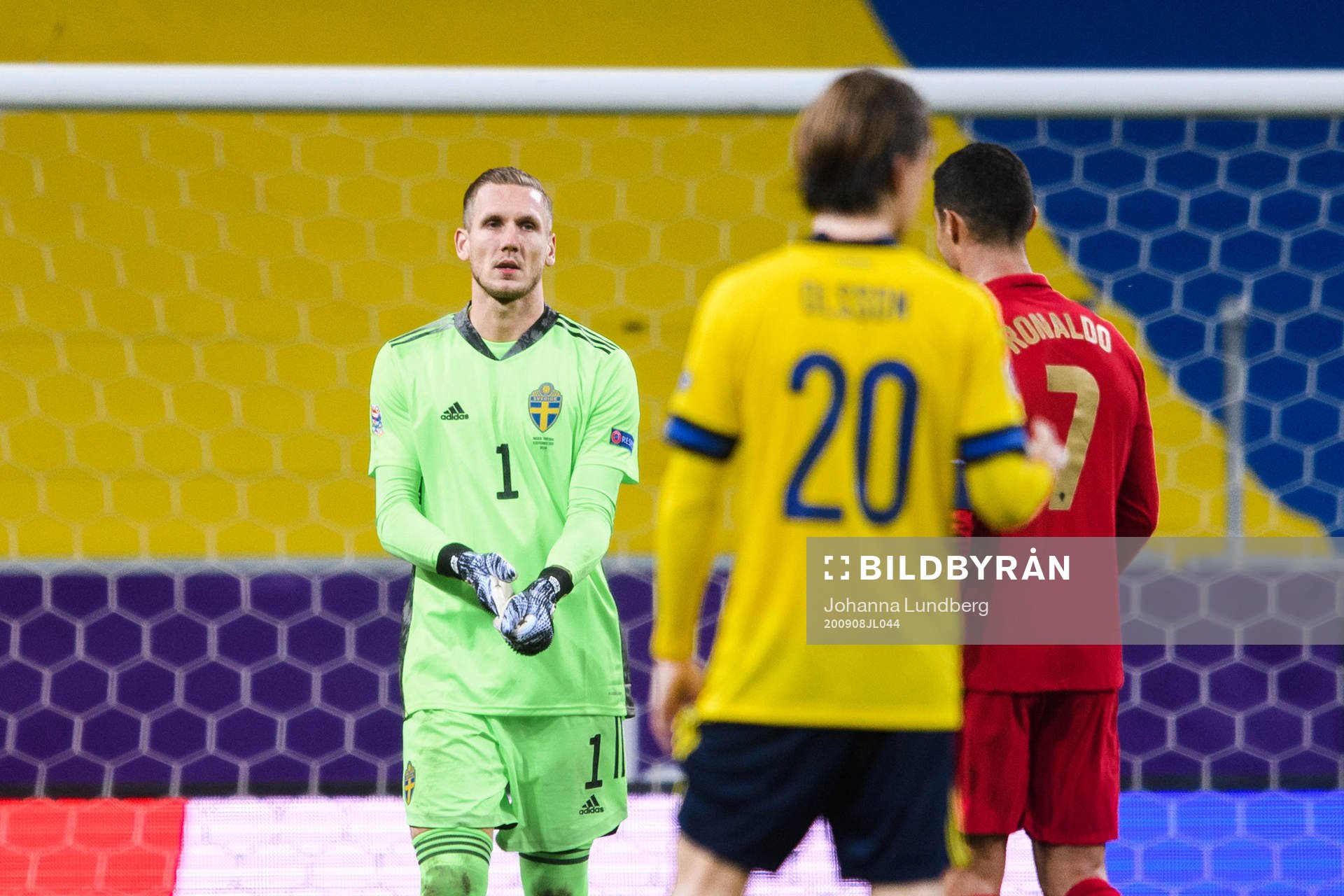 Goalkeeper Robin Olsen of Sweden and Cristiano Ronaldo of
