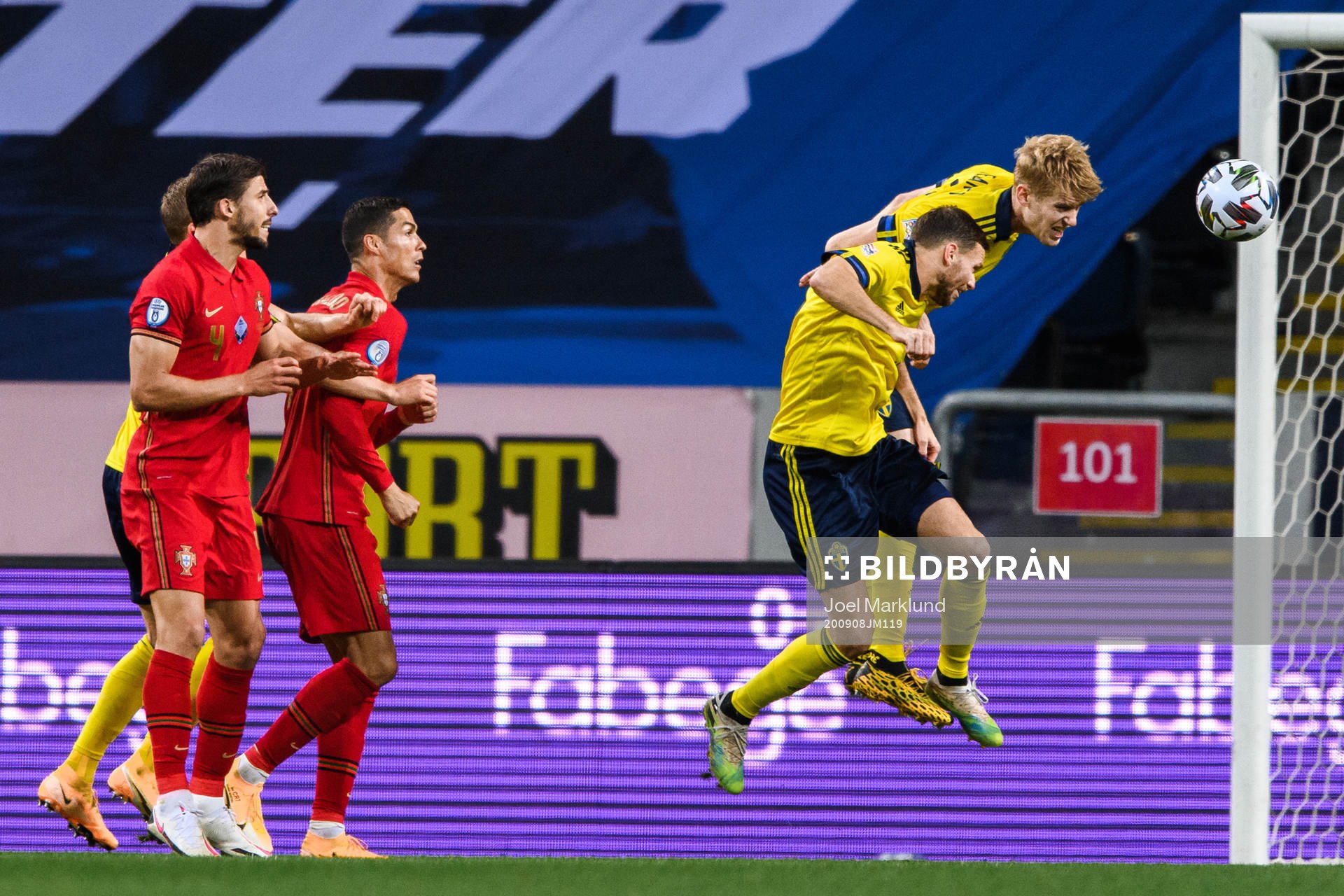 Marcus Berg and Filip Helander of Sweden against Ruben Dias