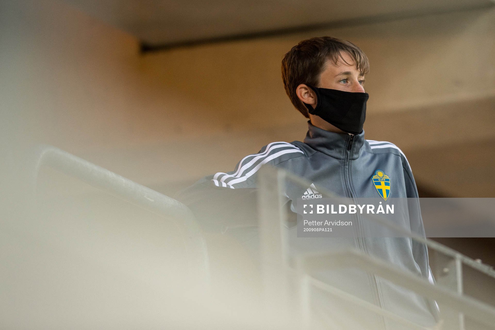 A ball boy with a face mask