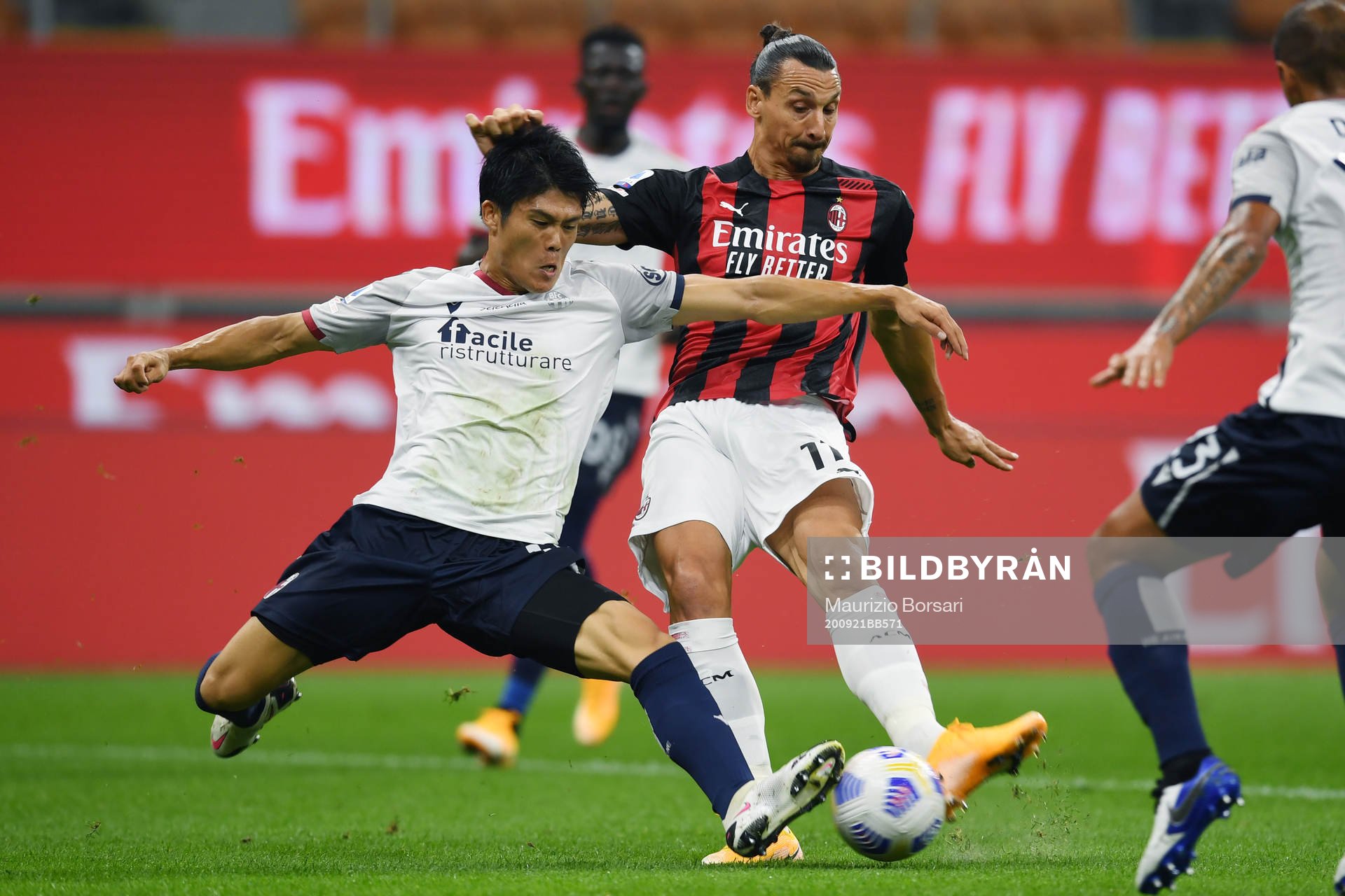 Zlatan Ibrahimovic of AC Milan against Takehiro Tomiyasu of