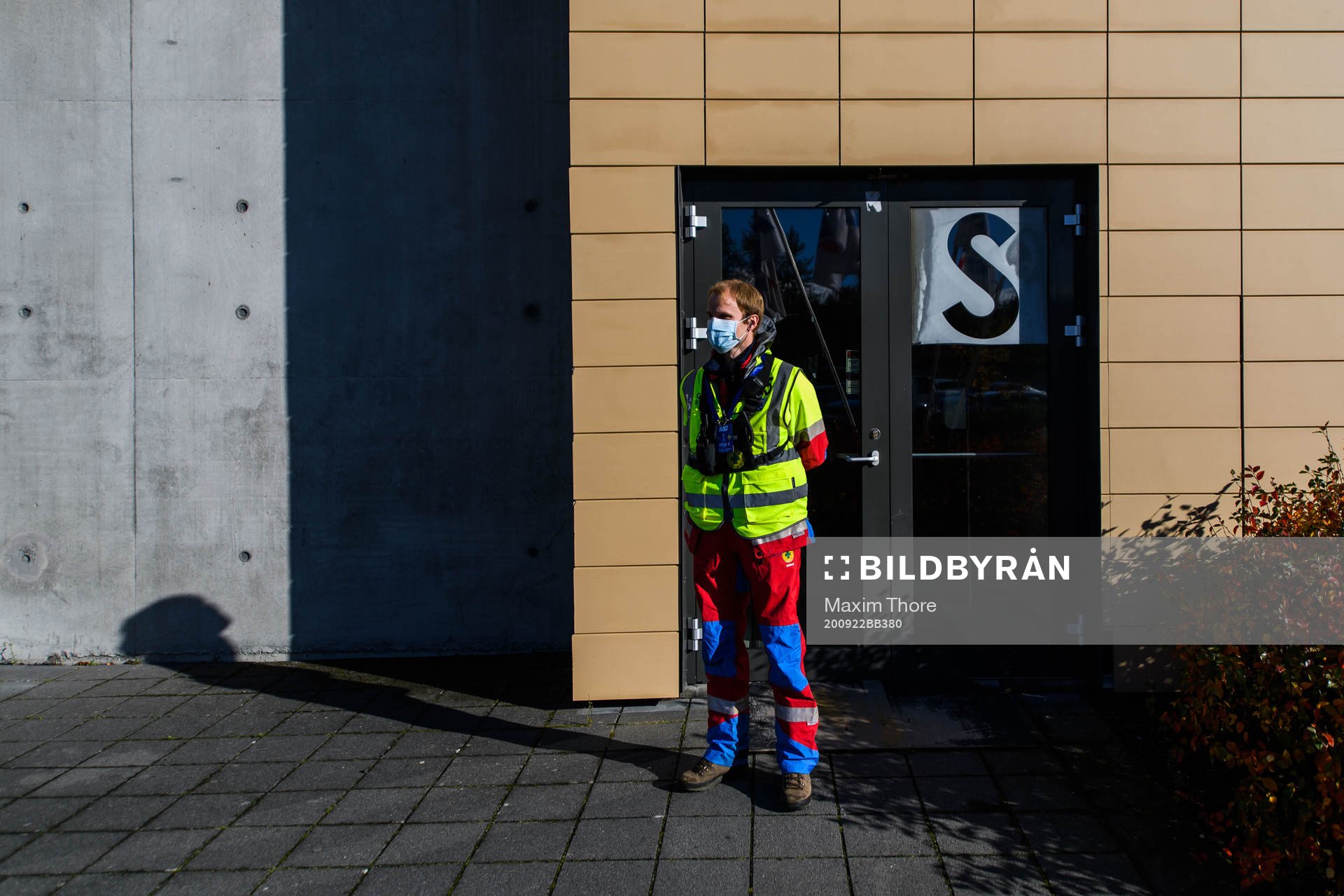 A steward outside Laugardalsvöllur stadium with a face