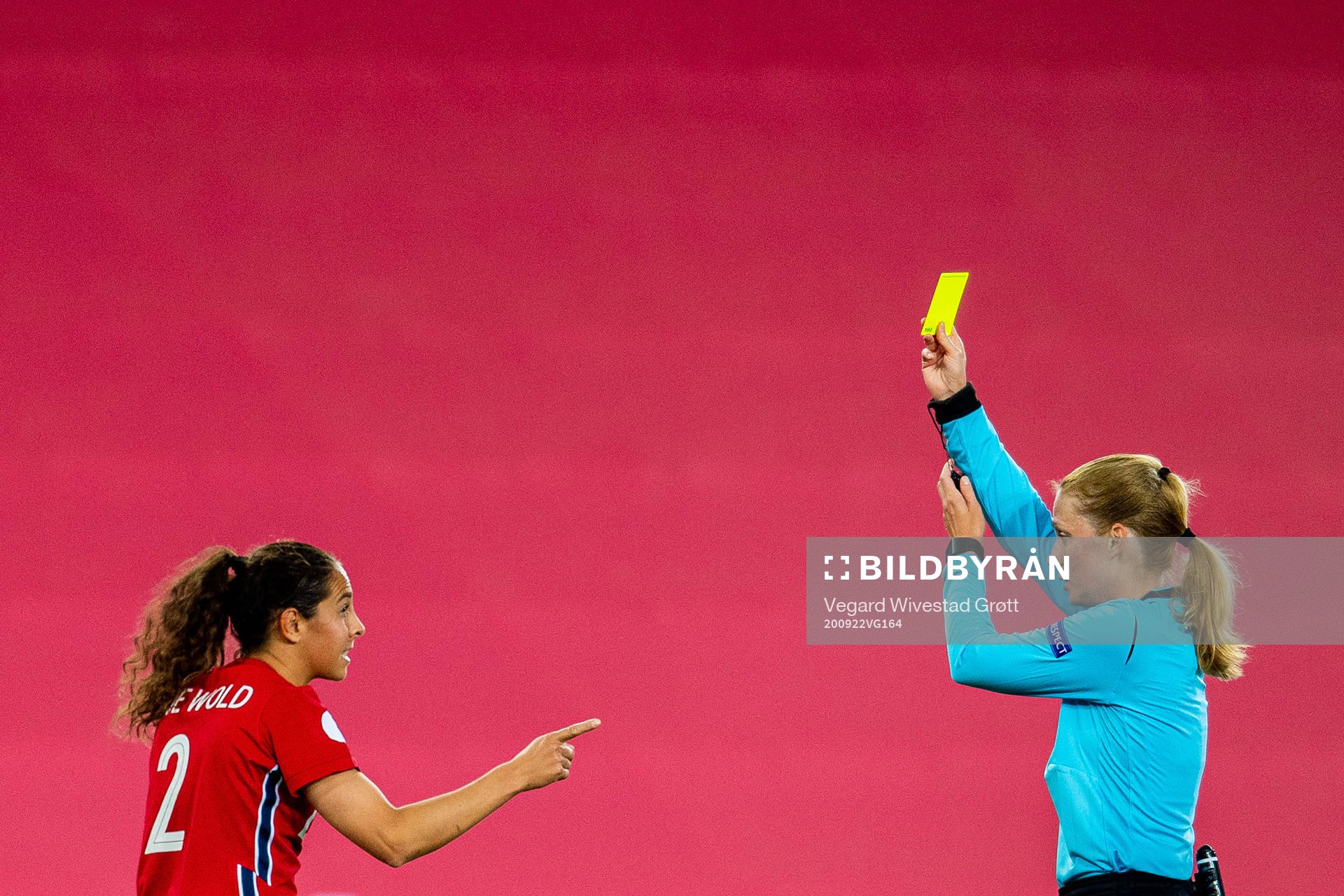 Ingrid Moe Wold of Norway receives a yellow card of referee