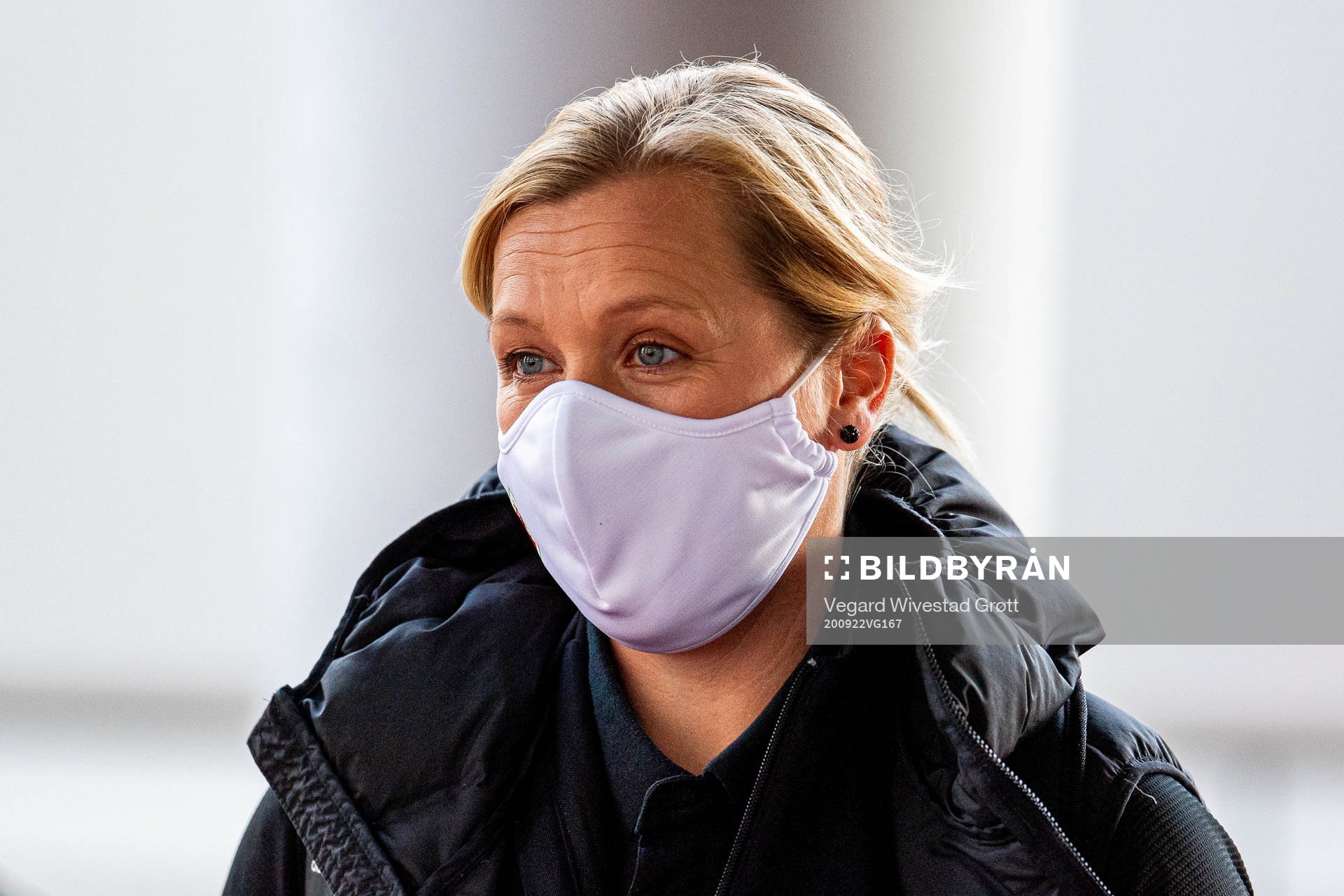 Jayne Ludlow, head coach of Wales, arrives wearing a face