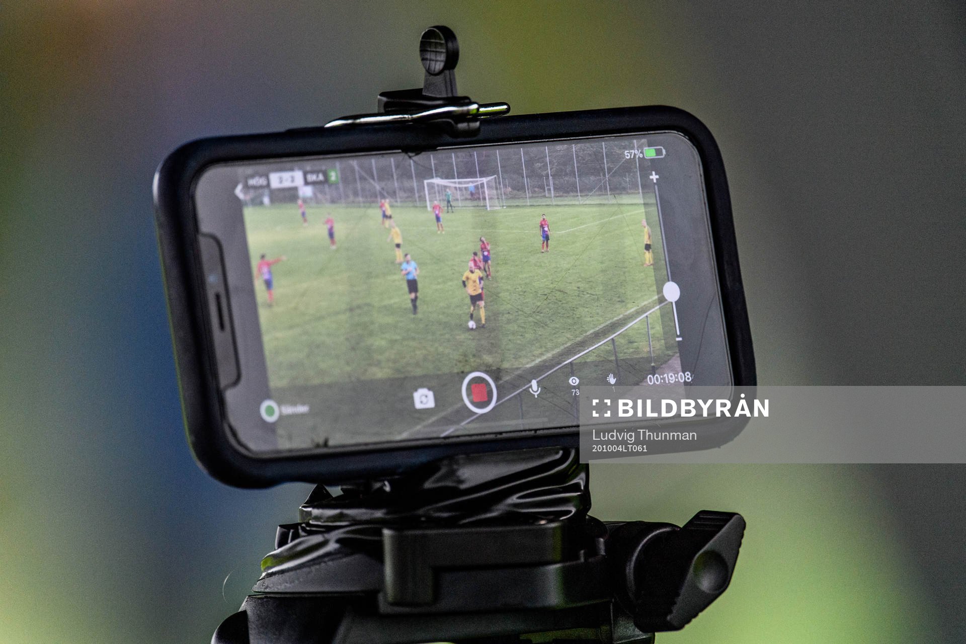 En mobiltelefon livesänder fotbollsmatchen i Division 3