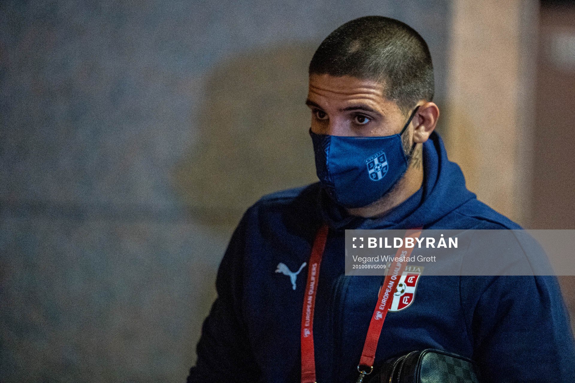 Aleksandar Mitrović of Serbia arrives wearing a face mask