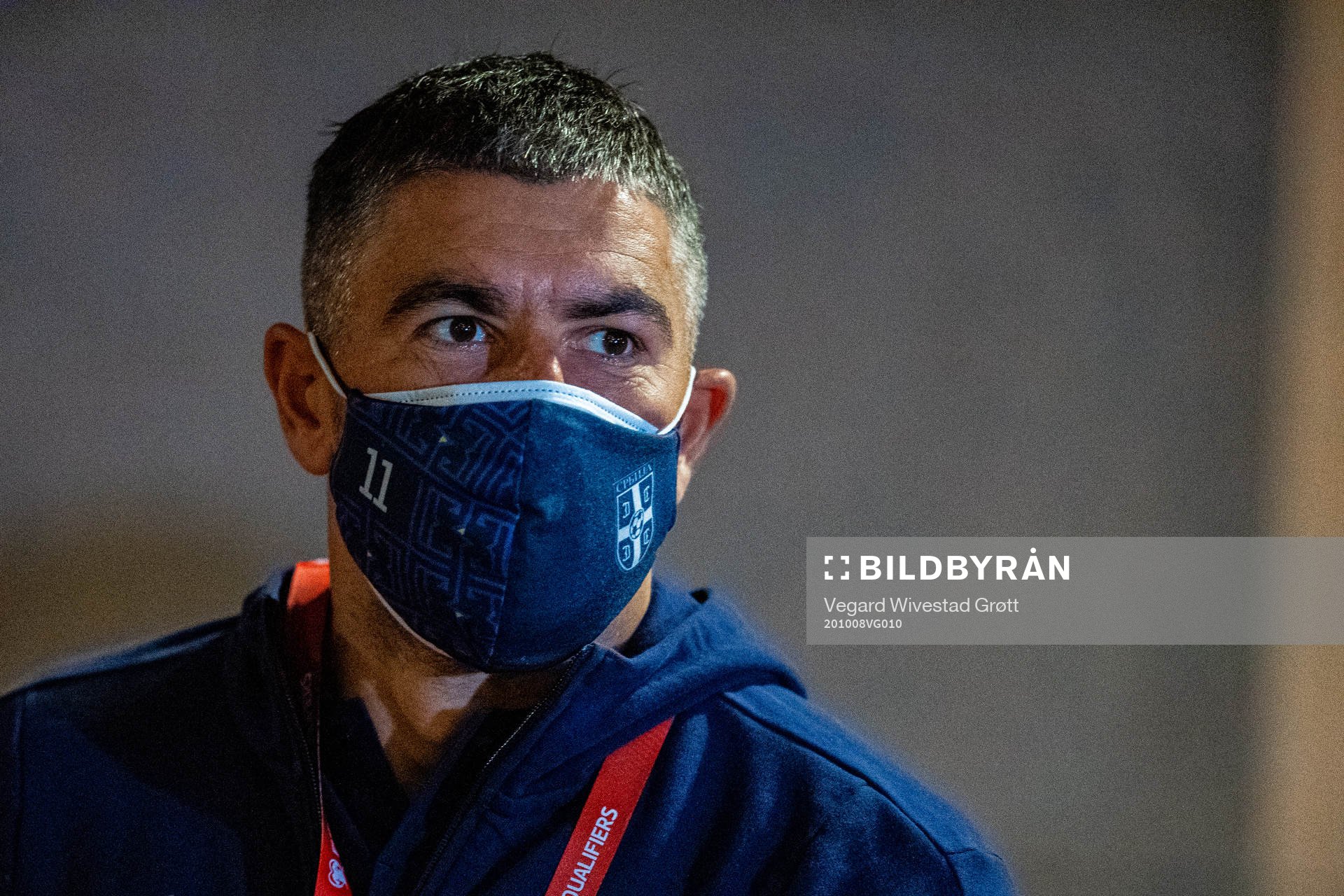 Aleksandar Kolarov of Serbia arrives wearing a face mask