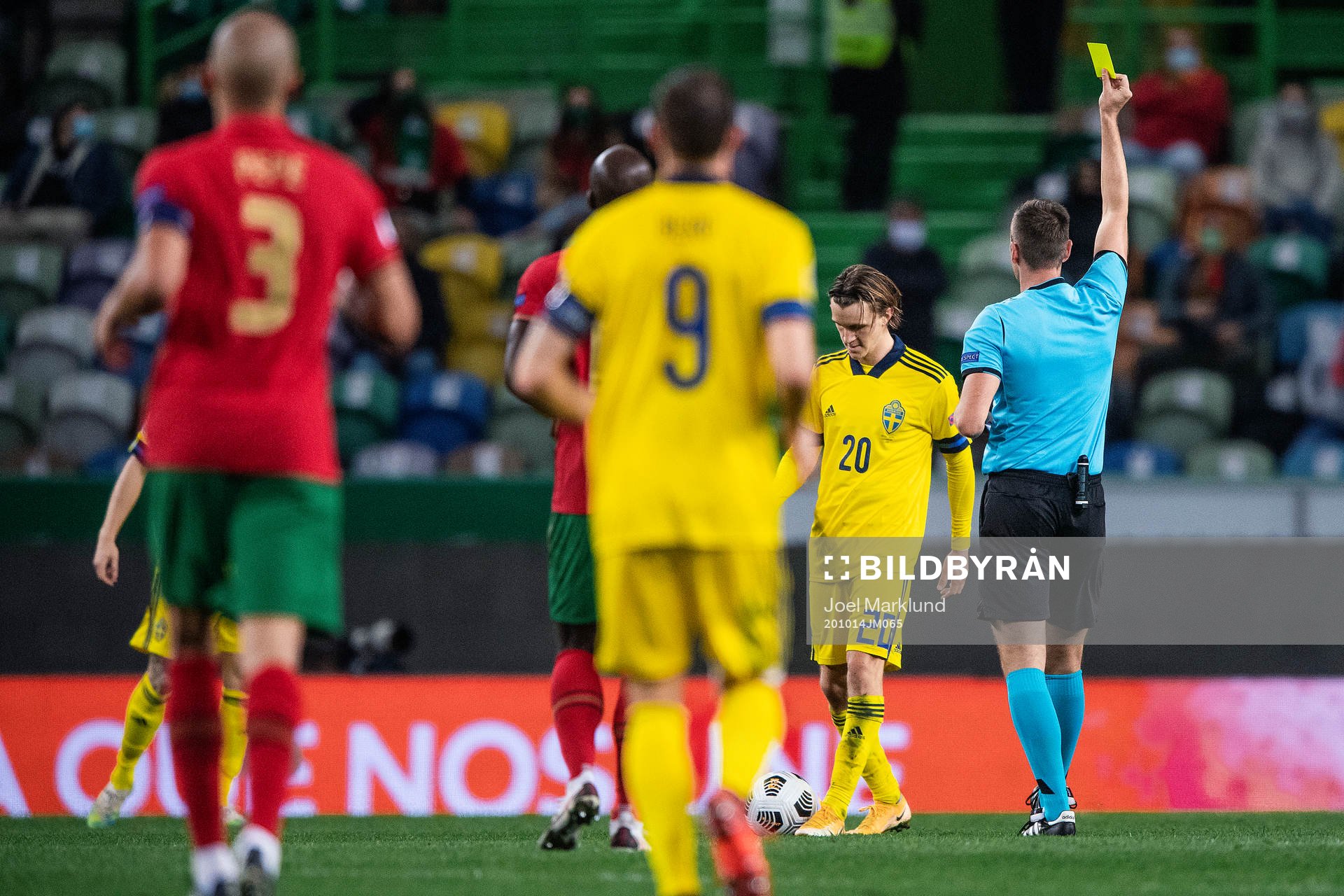 Kristoffer Olsson of Sweden receives a yellow card from