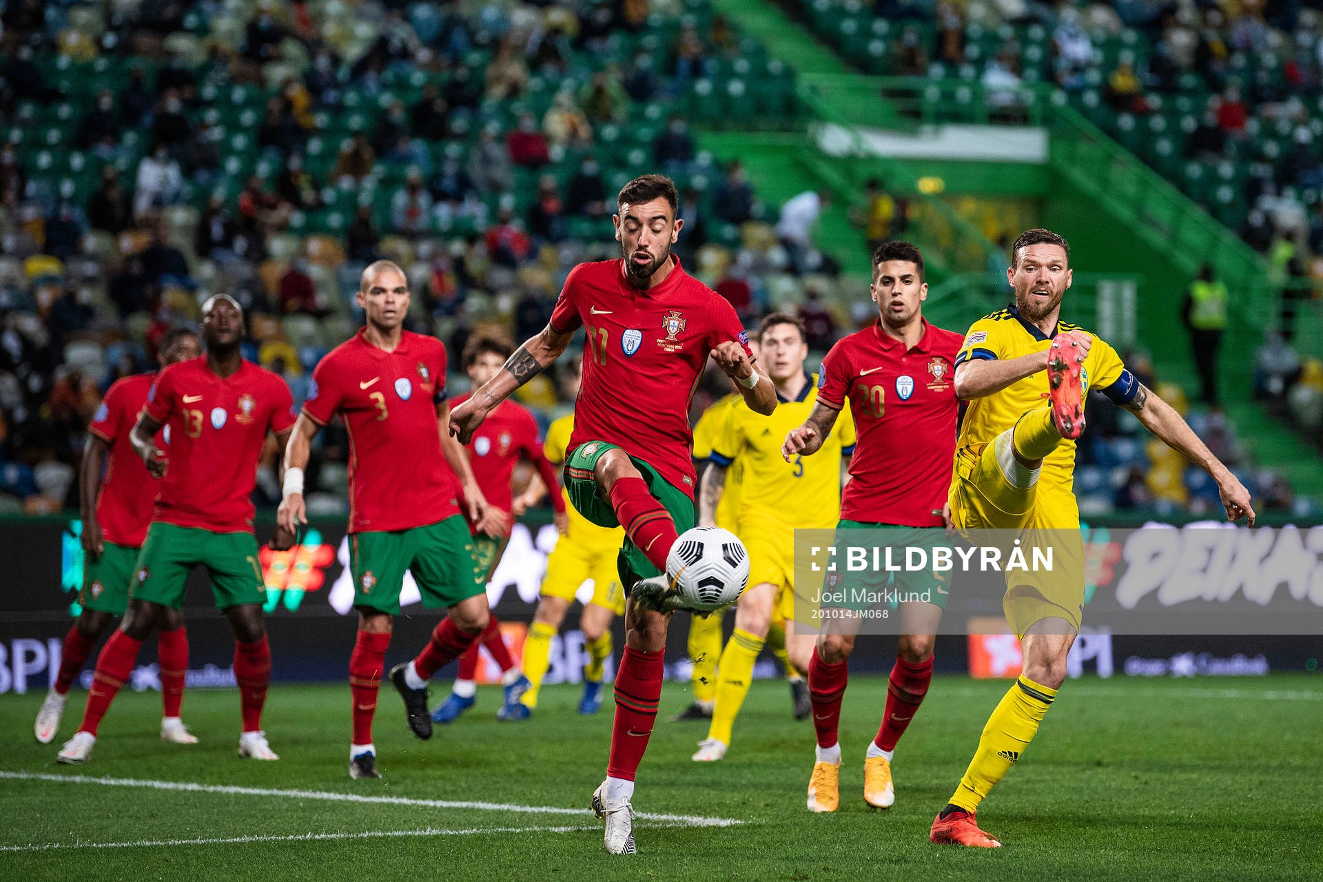 Bruno Fernandes of Portugal and Marcus Berg of Sweden