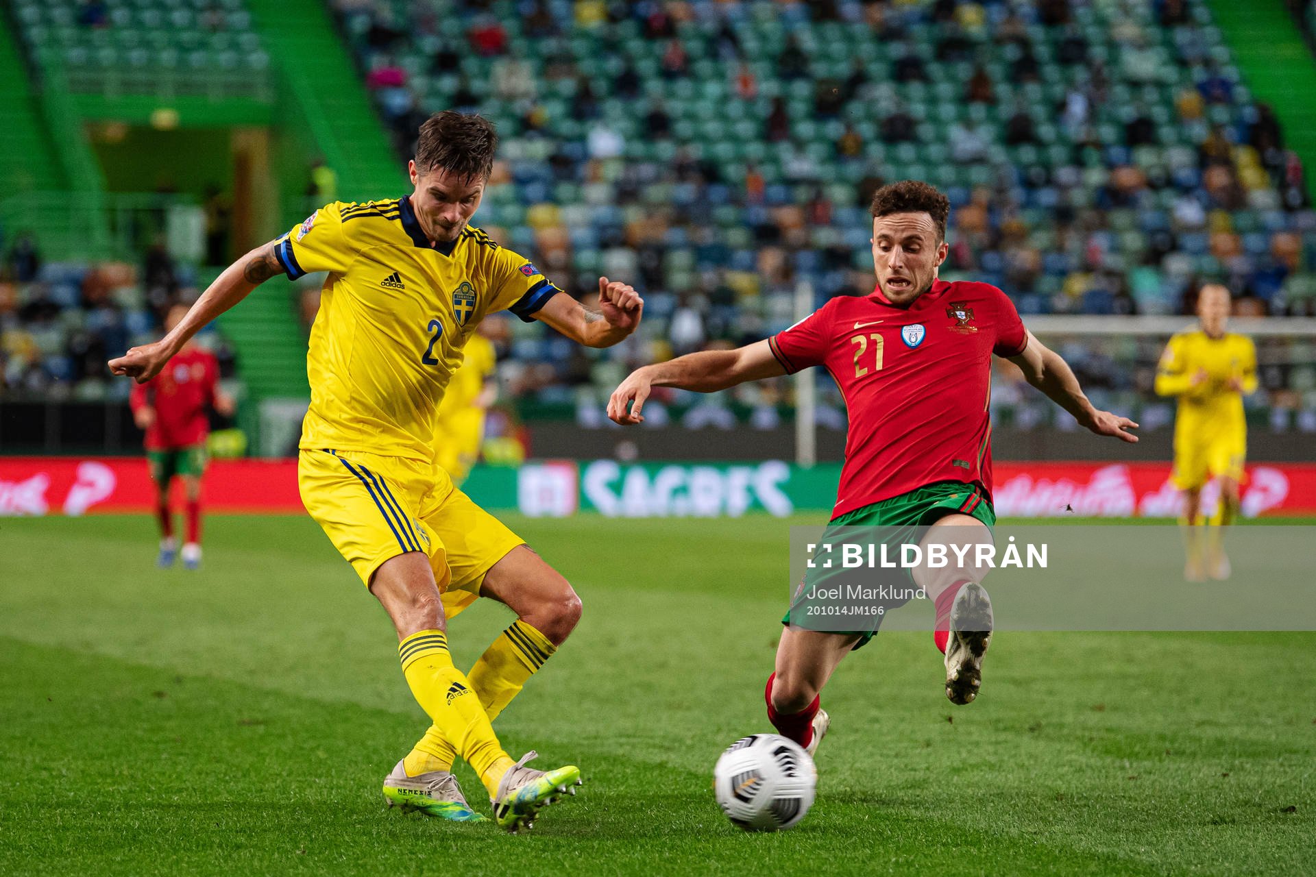 Mikael Lustig of Sweden and Diogo Jota of Portugal