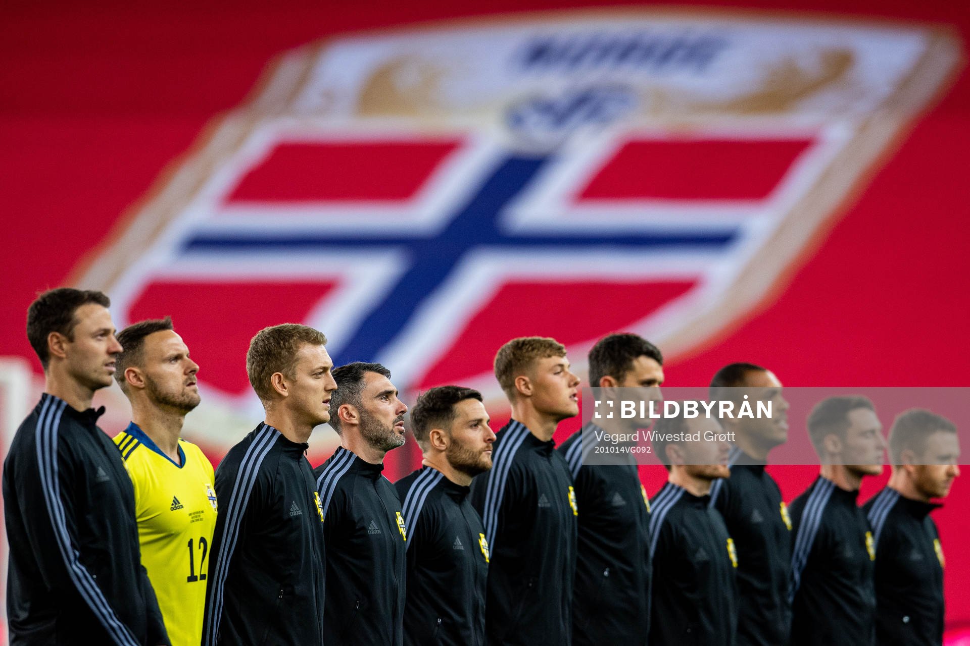 Michael Smith and the players of Northern Ireland line up