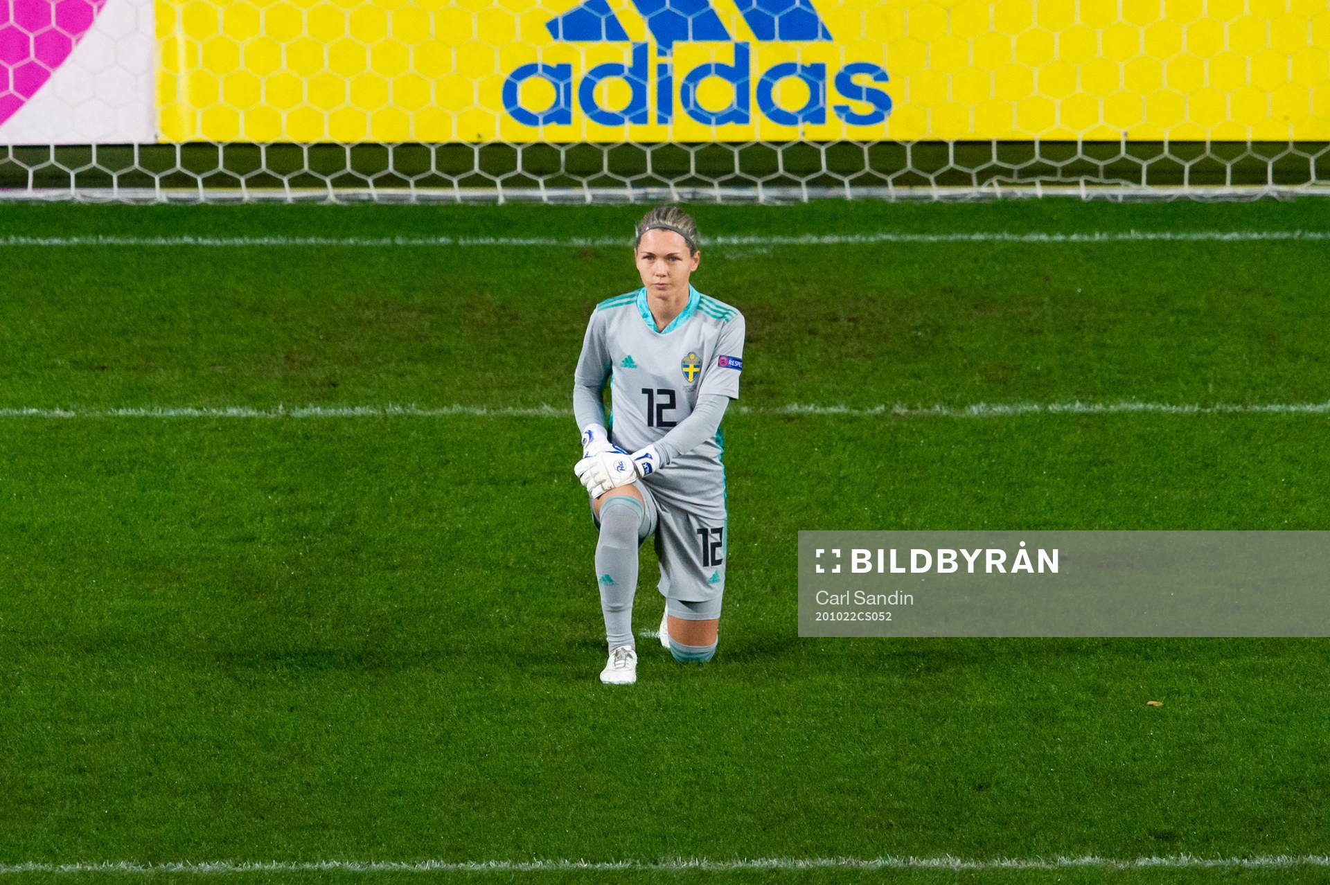 Goalkeeper Jennifer Falk of Sweden kneels in support of the