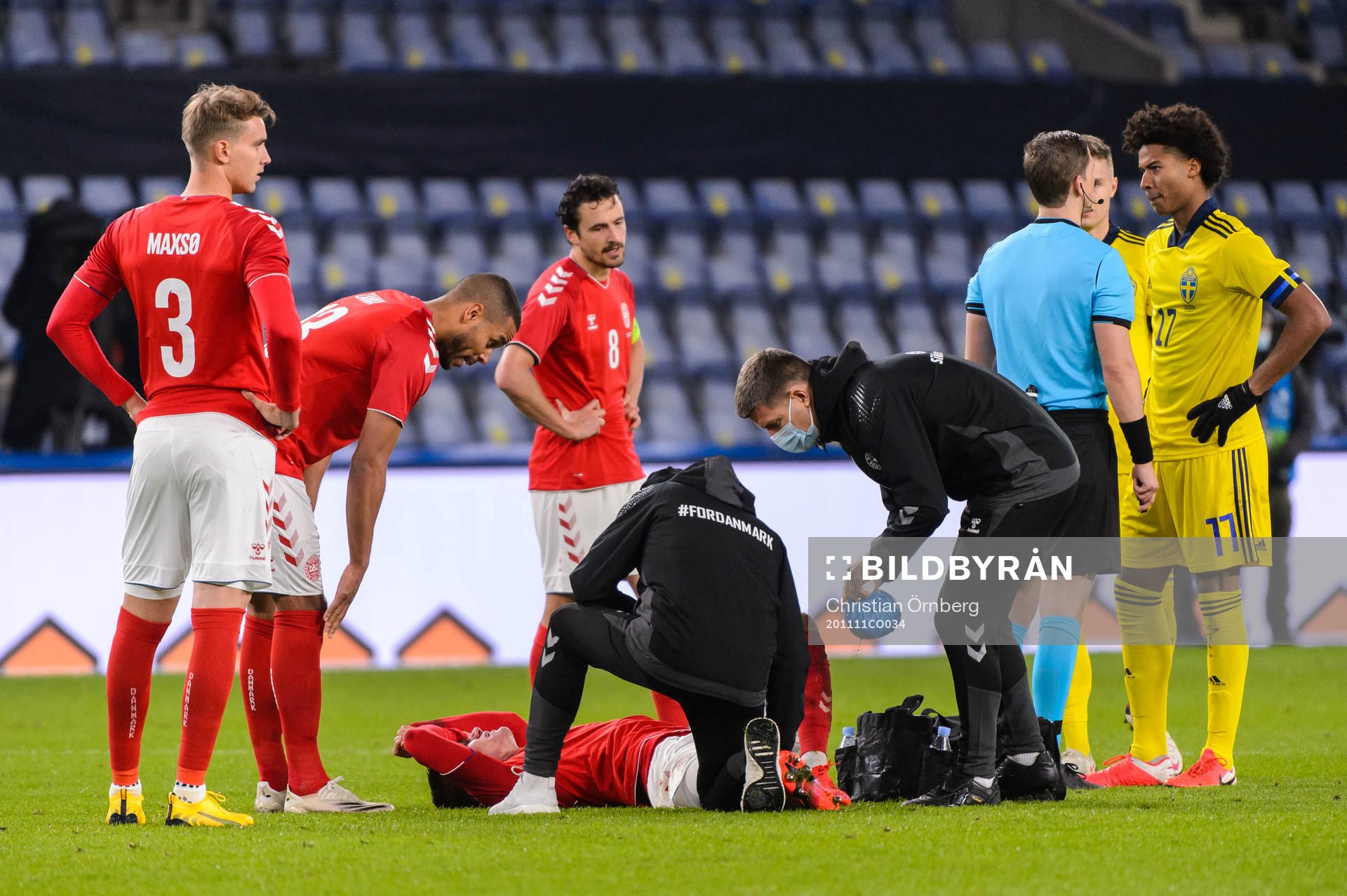 Joakim Mæhle of Denmark receives medical treatment
