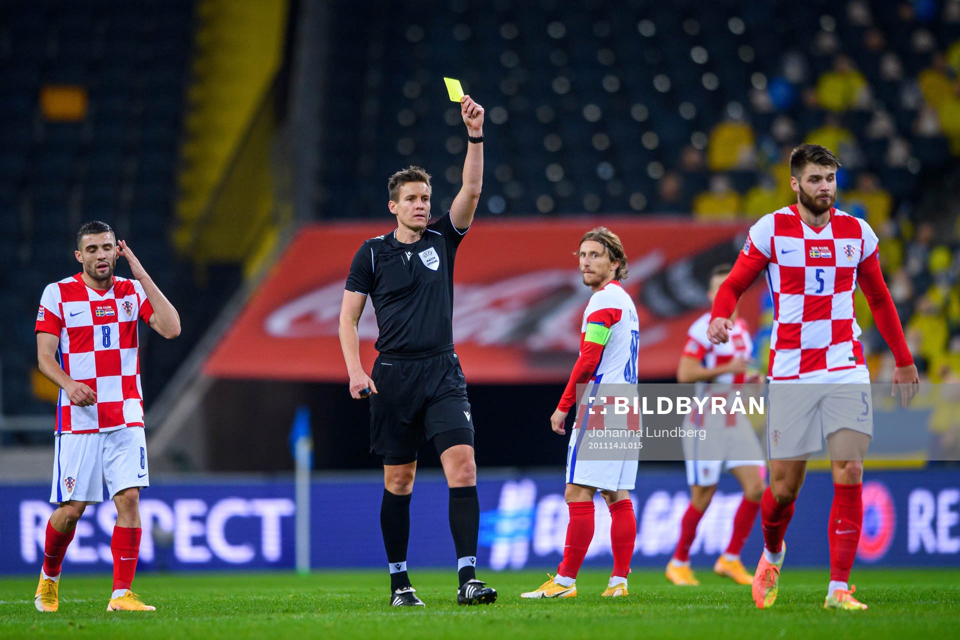 Duje Caleta-Car of Croatia receives a yellow card from
