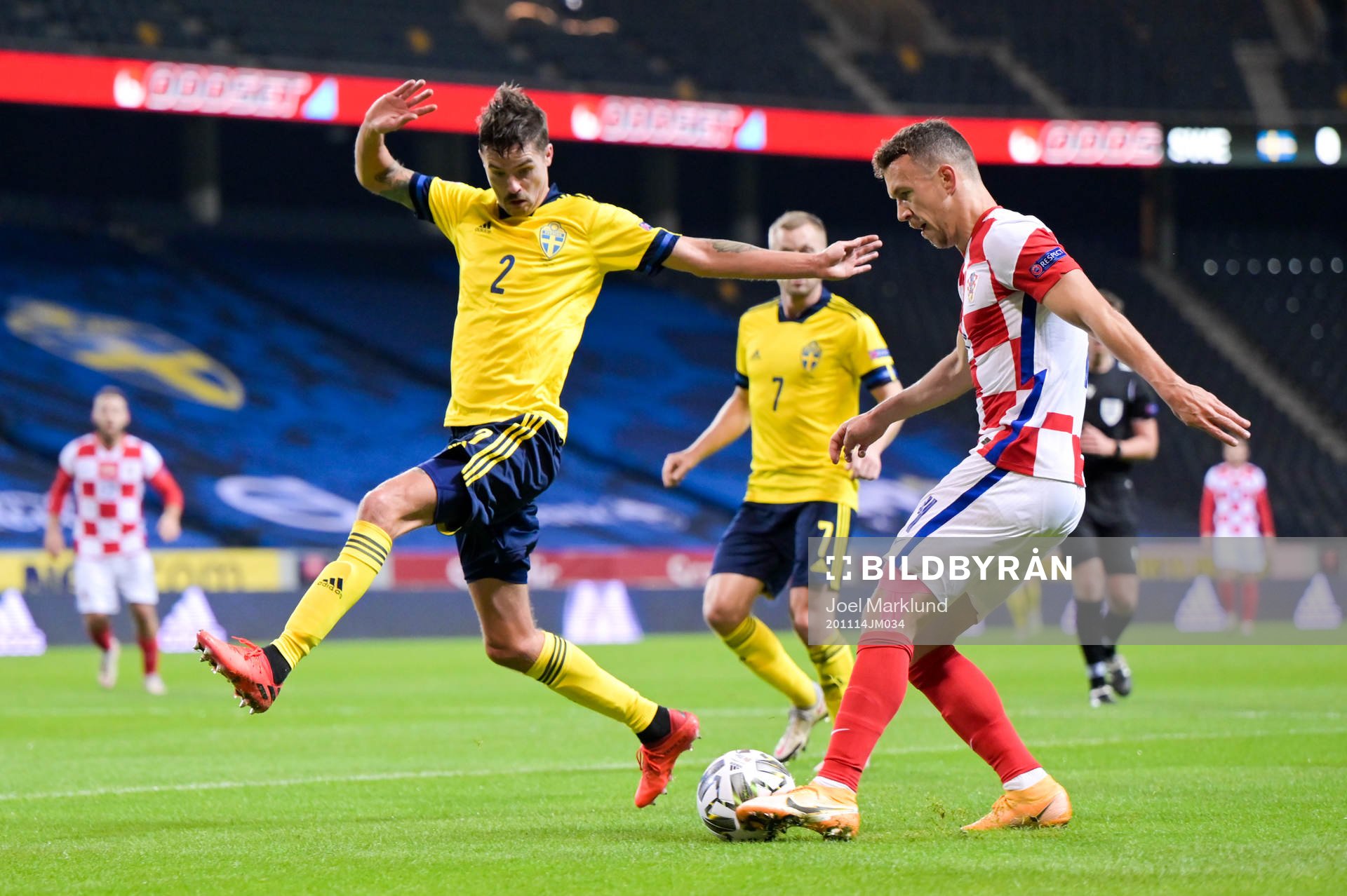 Mikael Lustig of Sweden and Ivan Perisic of Croatia