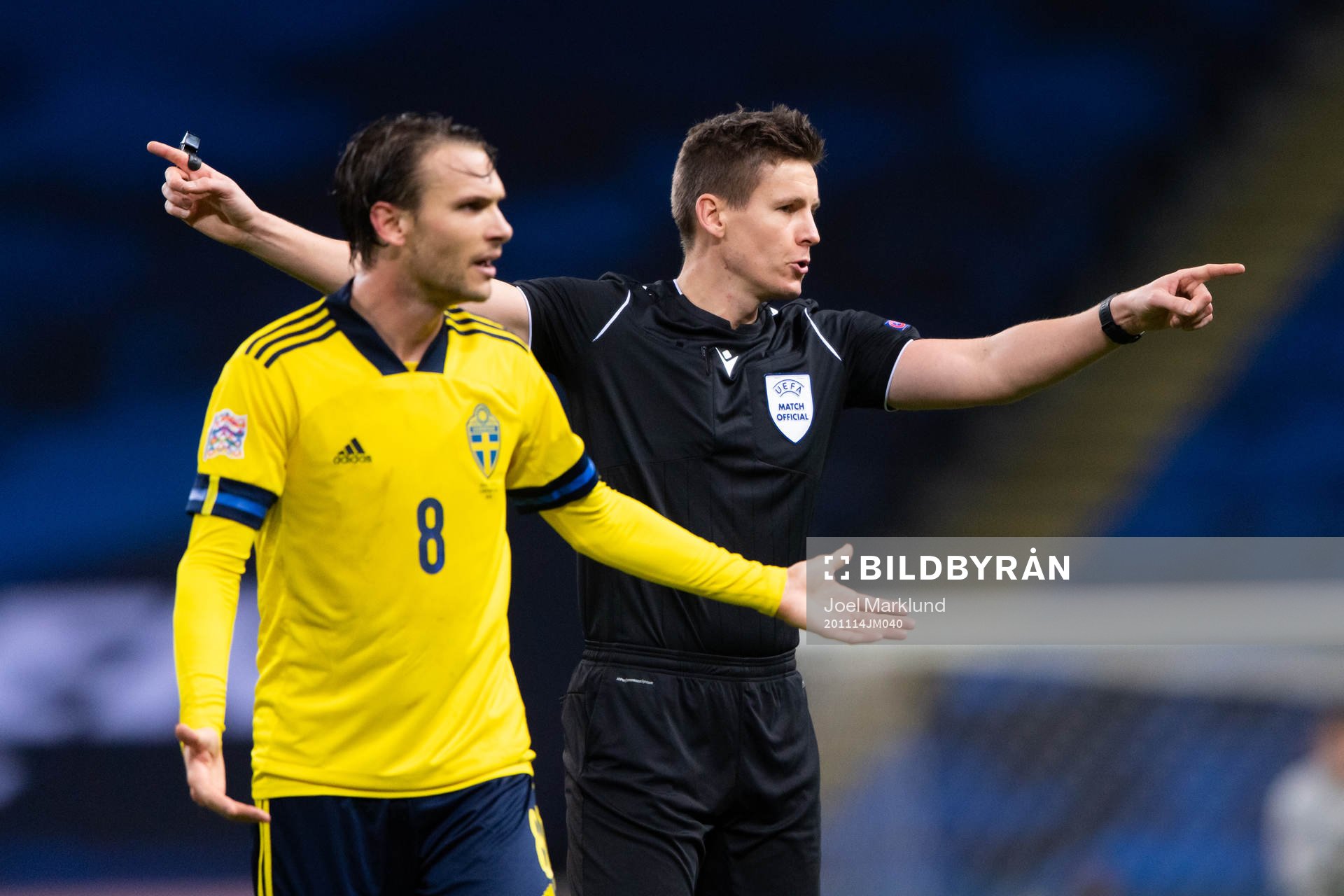Albin Ekdal of Sweden reacts beside referee Daniel Siebert