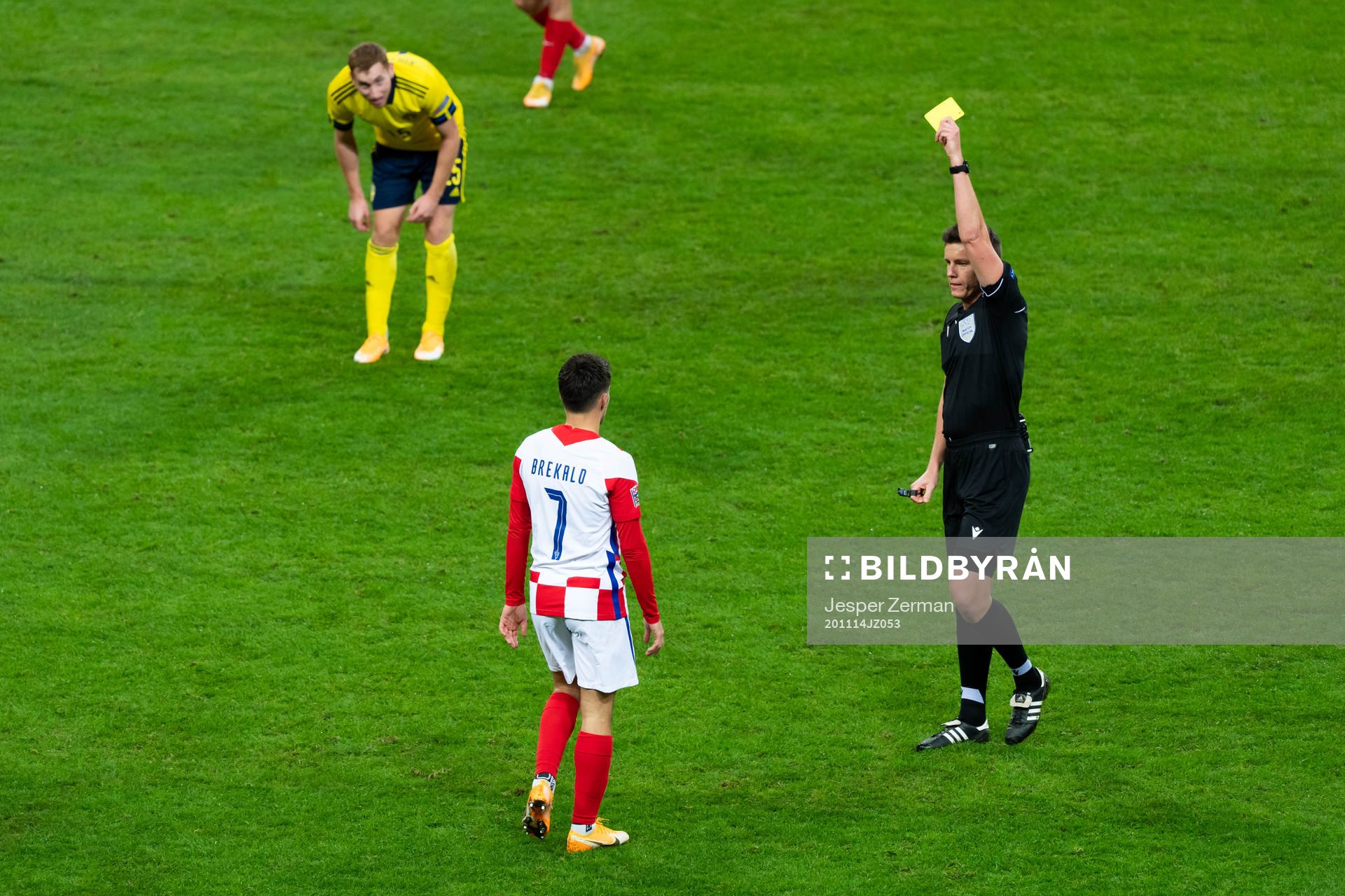 Josip Brekalo of Croatia is shown a yellow card by referee