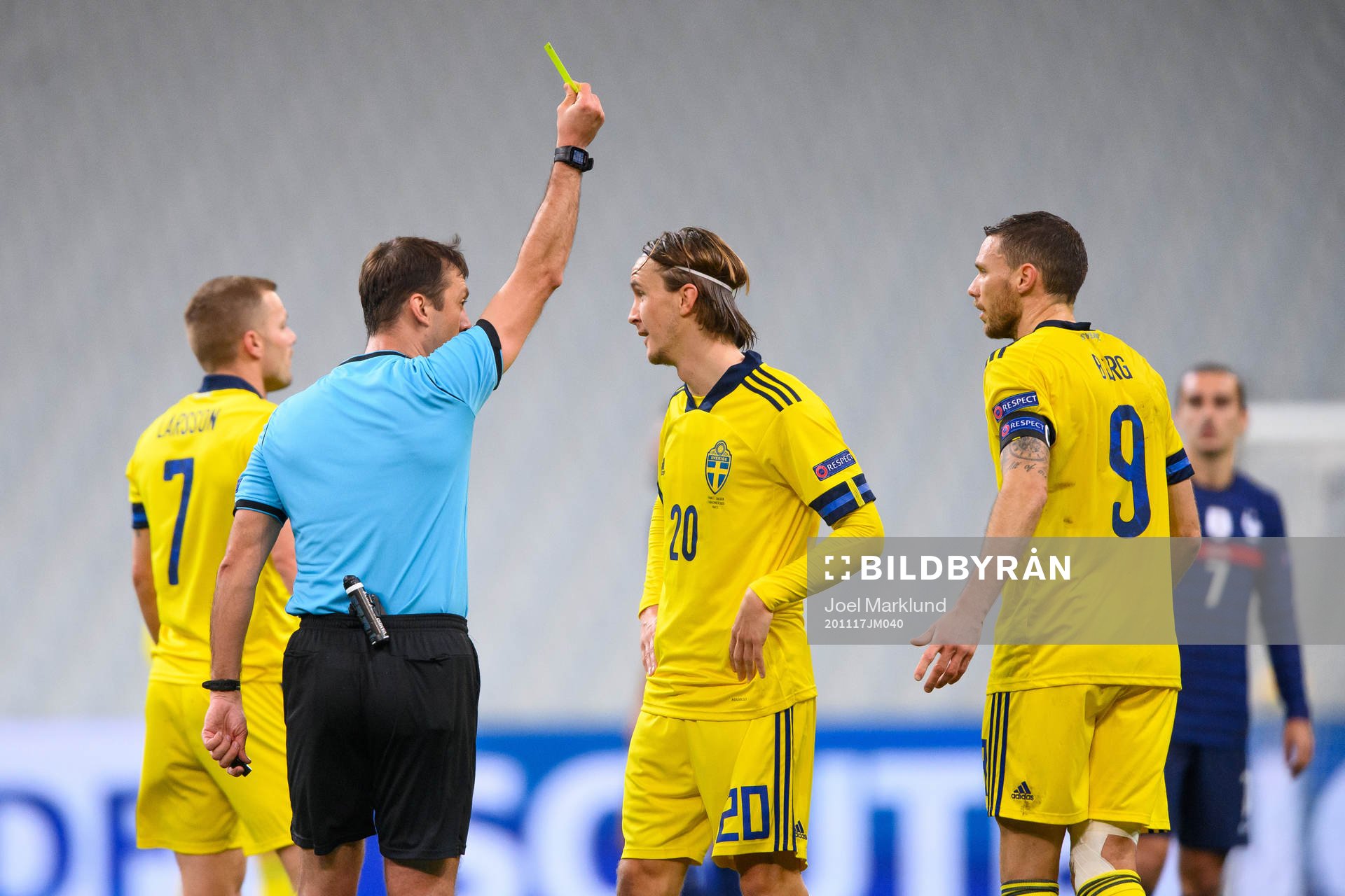 Kristoffer Olsson of Sweden receives a yellow card