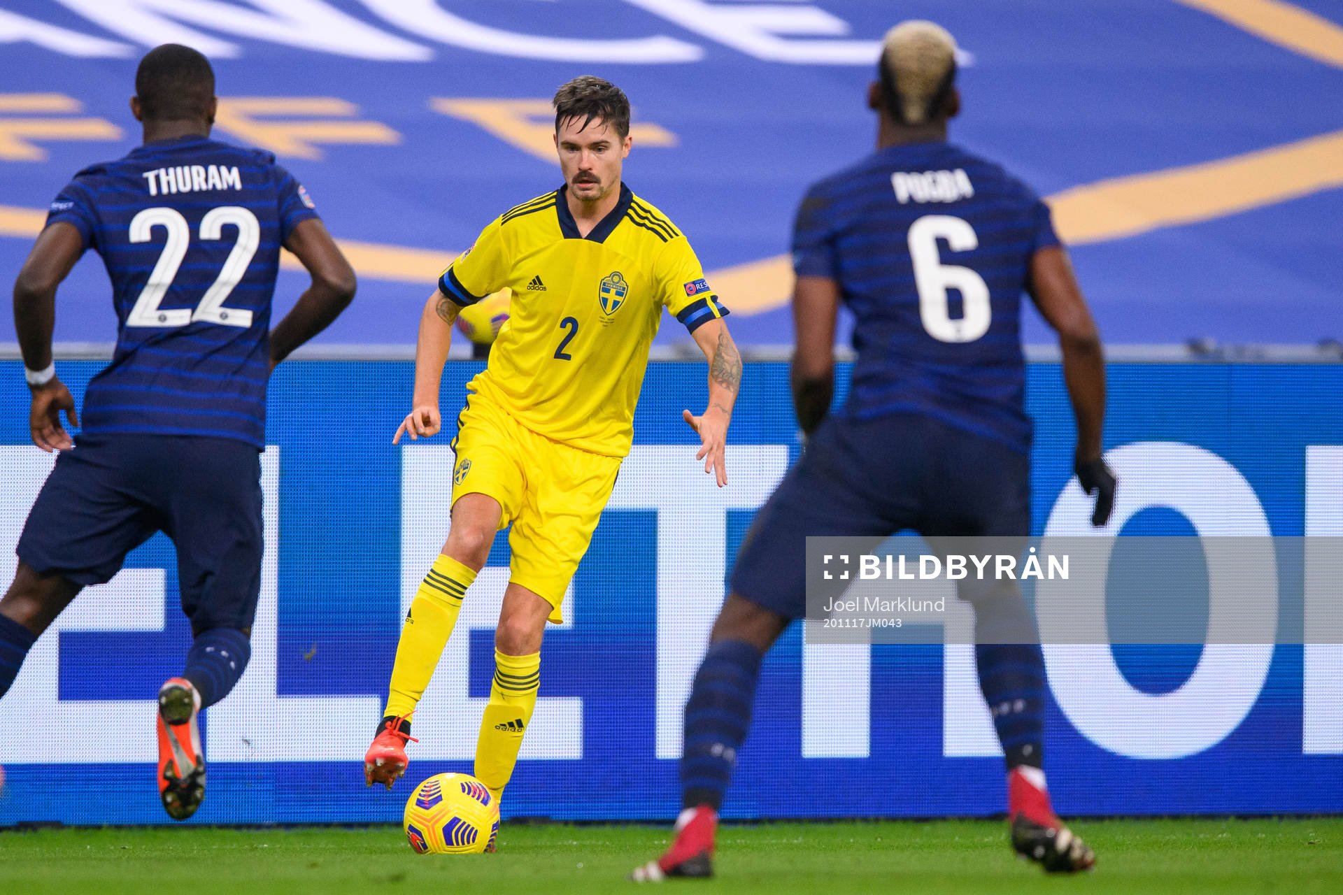 Mikael Lustig of Sweden against Marcus Thuram and Paul