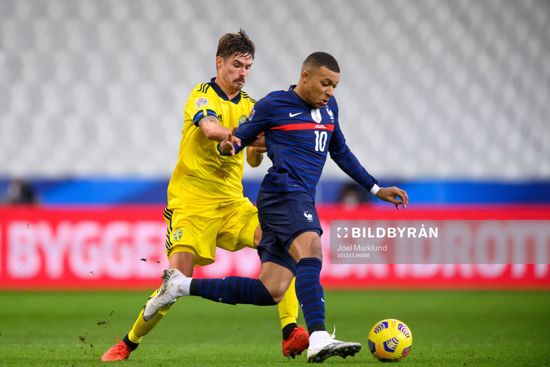 Mikael Lustig of Sweden and Kylian Mbappé of France