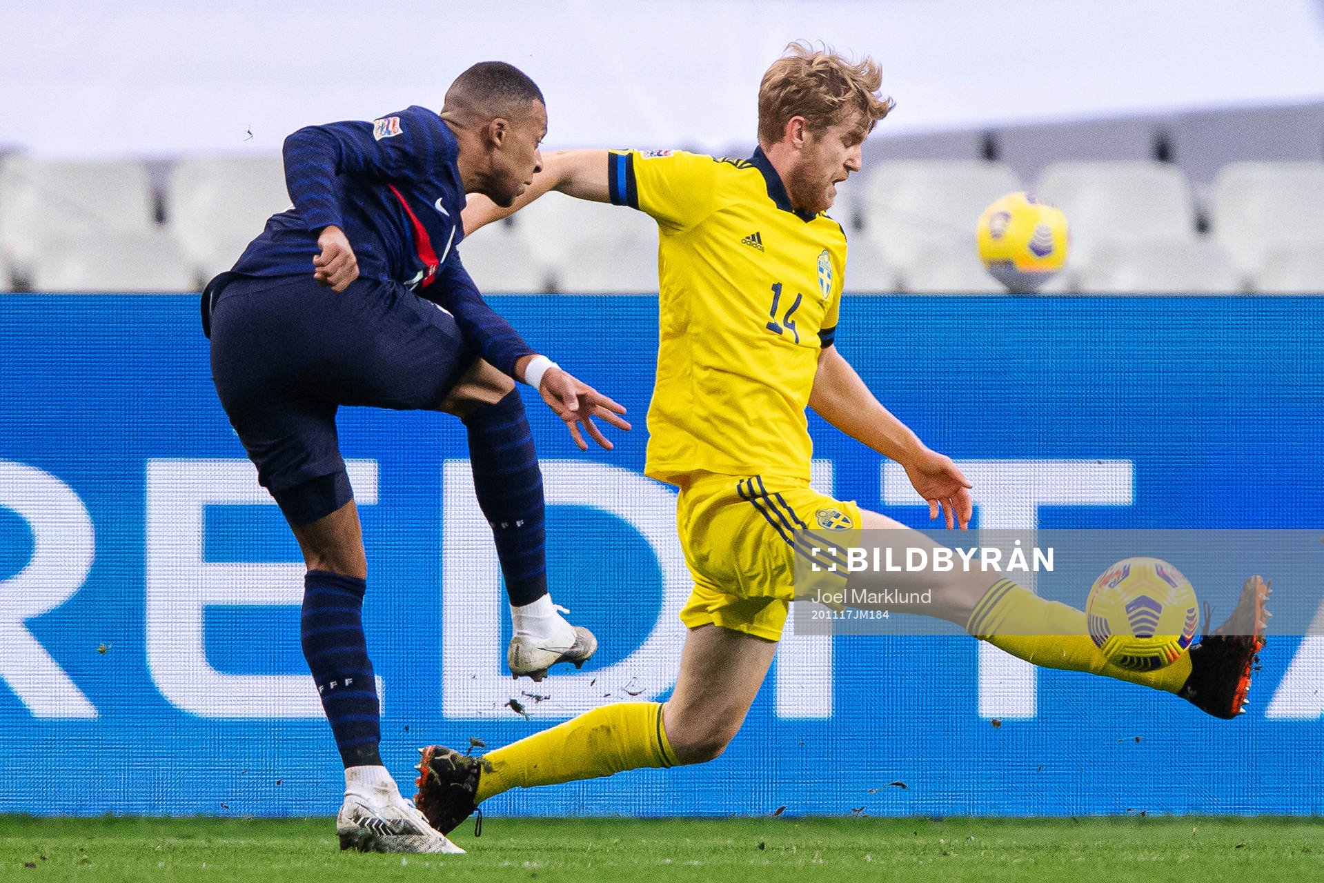 Kylian Mbappé of France and Filip Helander of Sweden