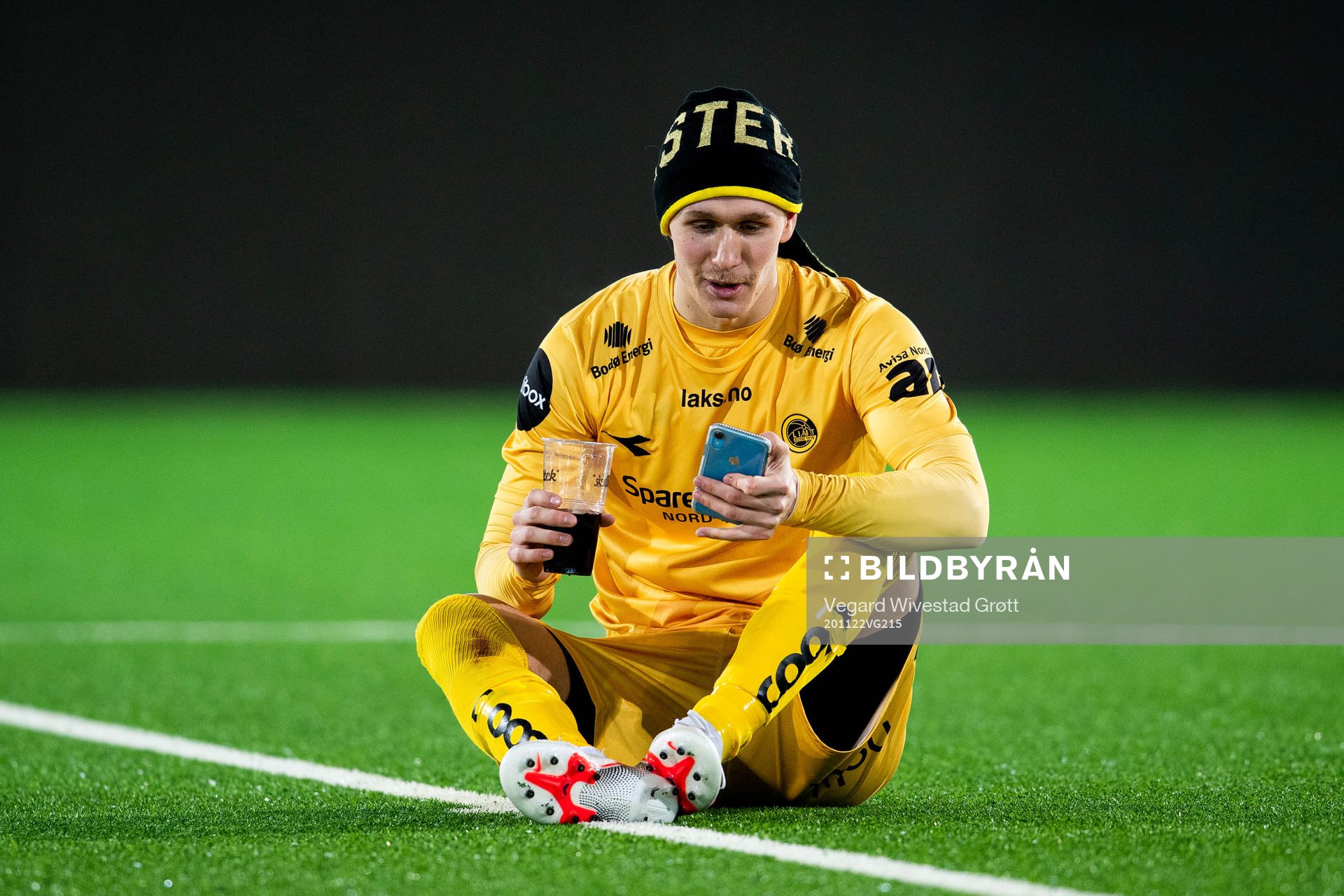 Ola Solbakken of Bodø/Glimt celebrates winning the league while calling on facetime on his iPhone after the Eliteserien football match between Strømsgodset and Bodø/Glimt on November 22, 2020 in Drammen.