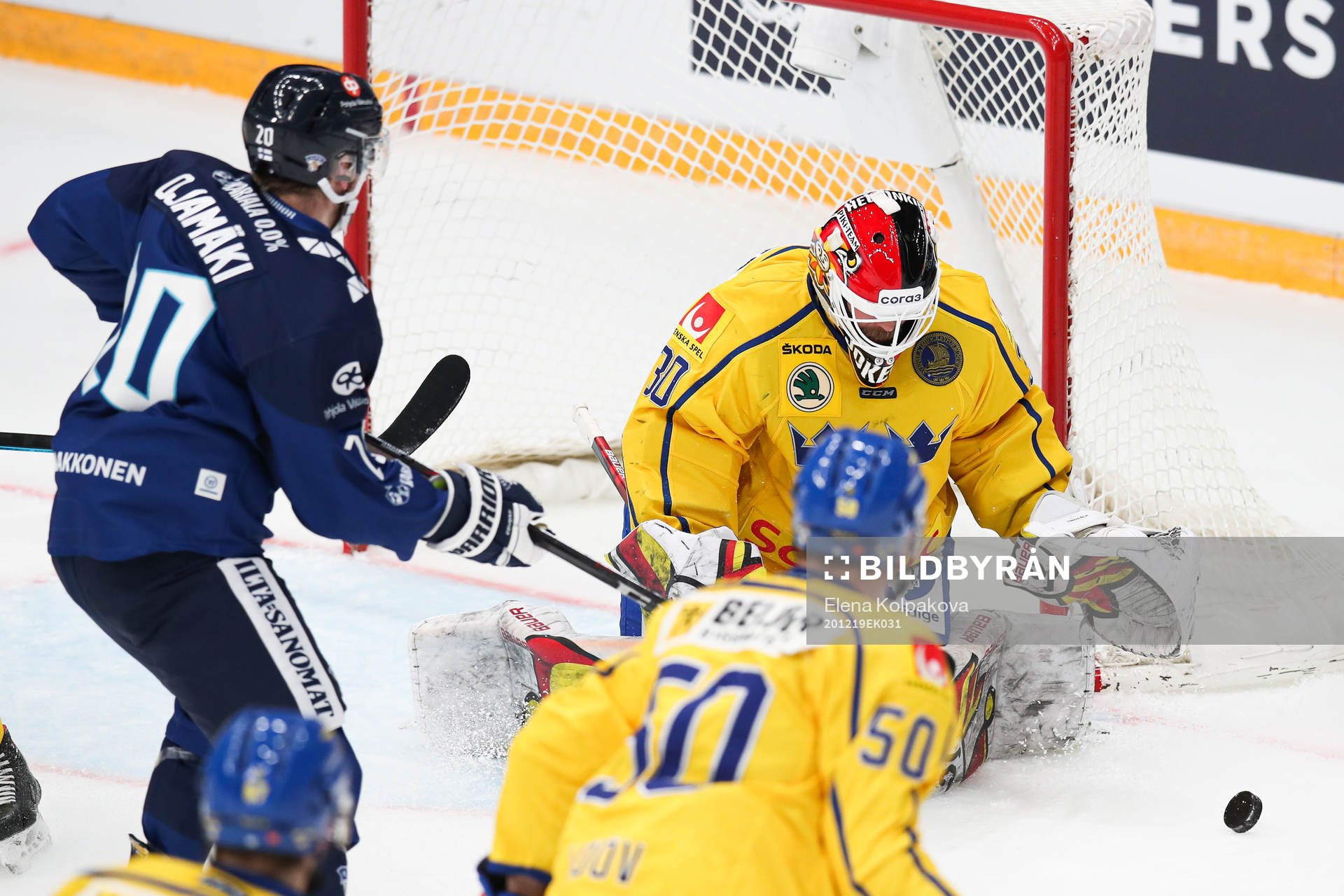 Niko Ojamaki of Finland and goalkeeper Anders Lindbäck of