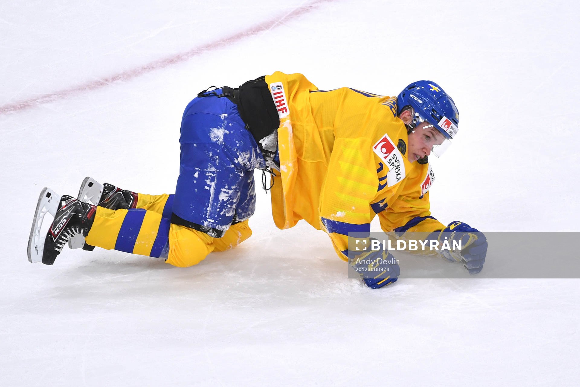 Arvid Costmar of Sweden falls to the ice