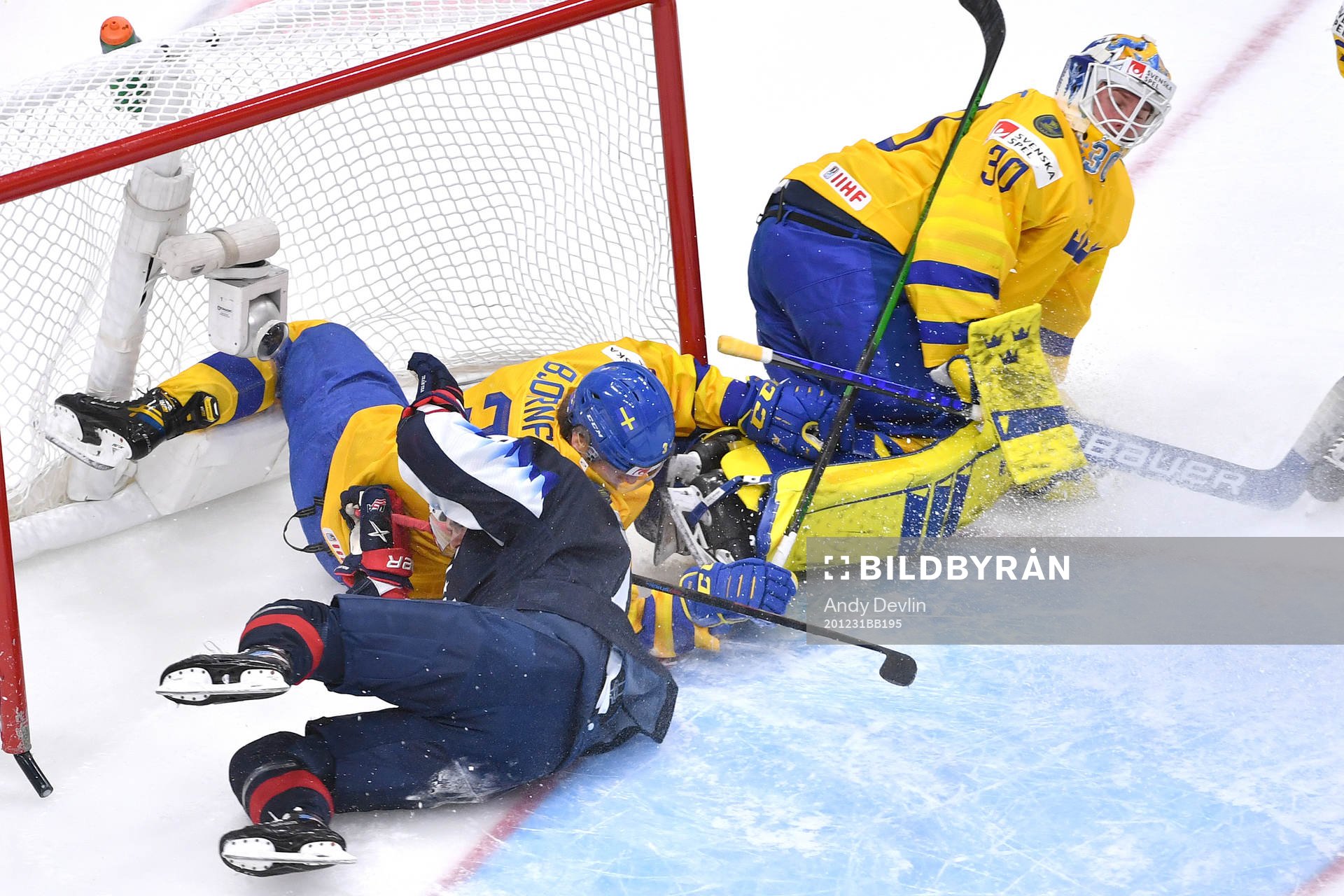 Alex Turcotte of USA and Tobias Björnfot of Sweden collide