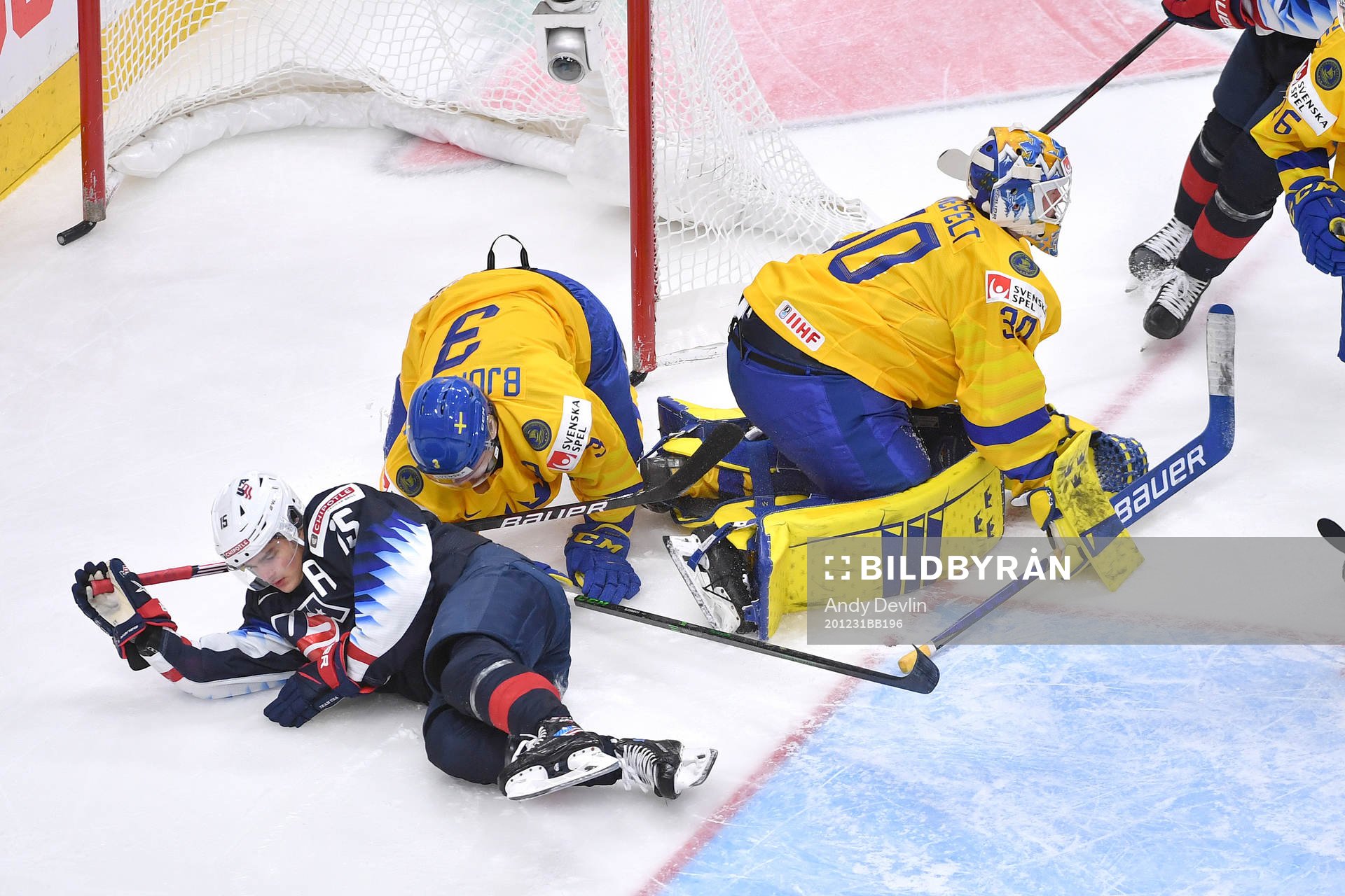 Alex Turcotte of USA and Tobias Björnfot of Sweden collide
