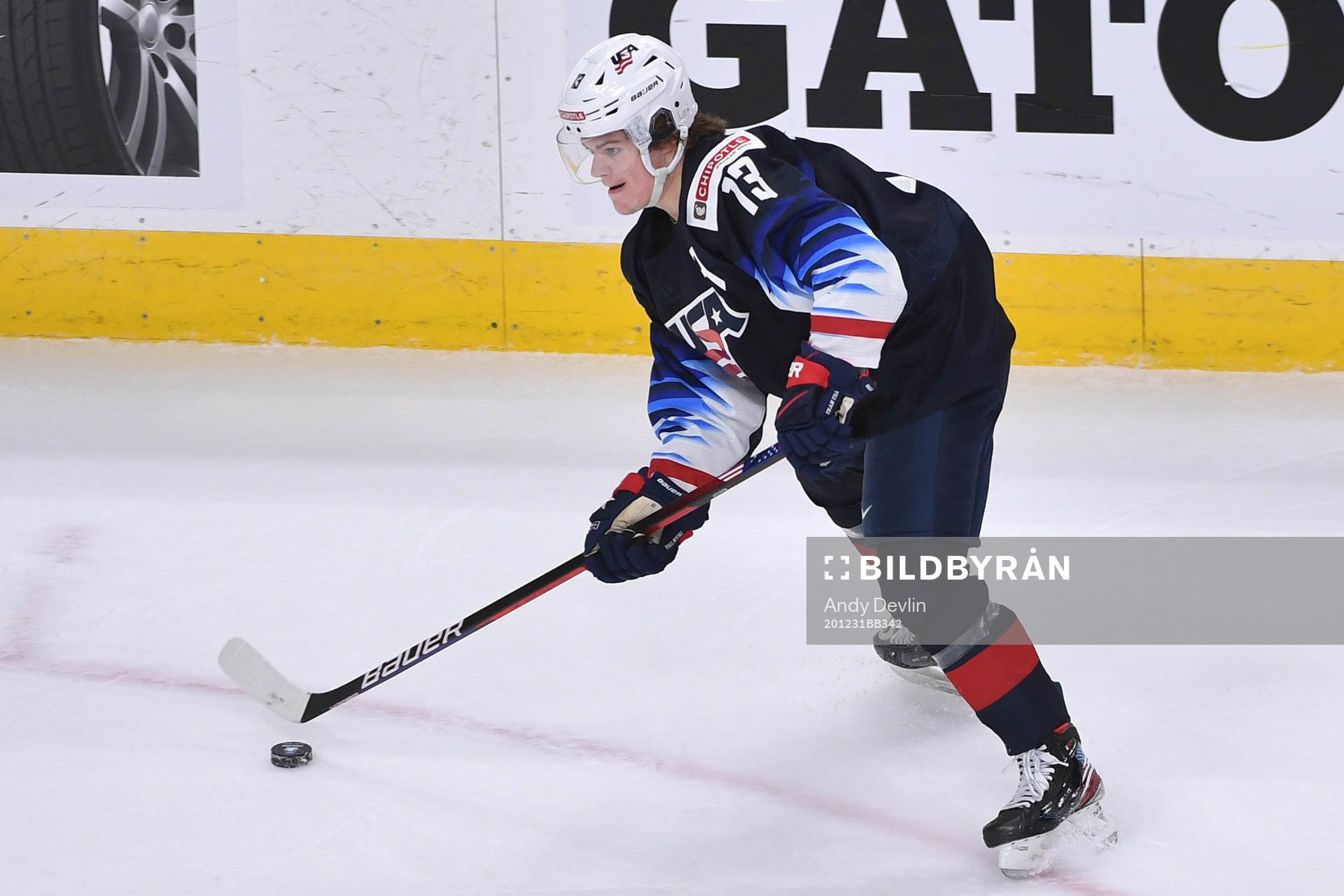 Cole Caufield of USA handles the puck